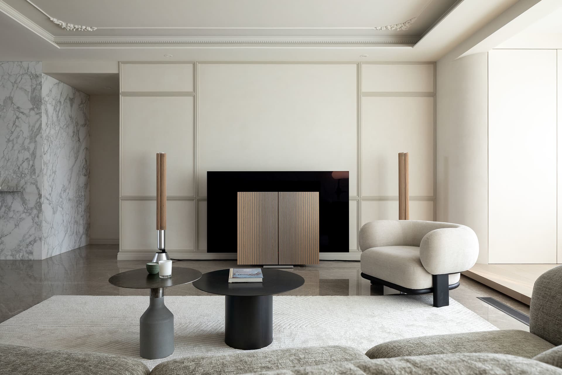 Modern, minimalist living room featuring marble accents, wood furniture, and leather seating.