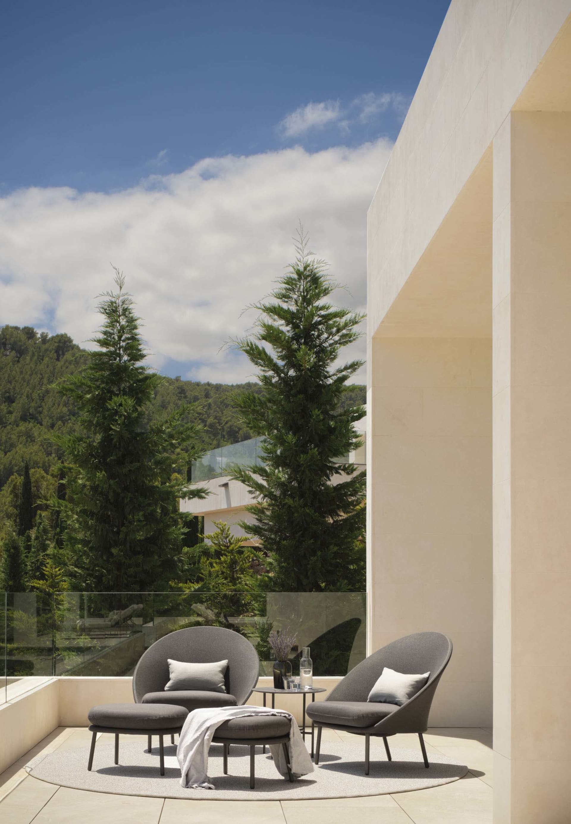 Outdoor seating area with concrete furniture and minimalist design on a balcony