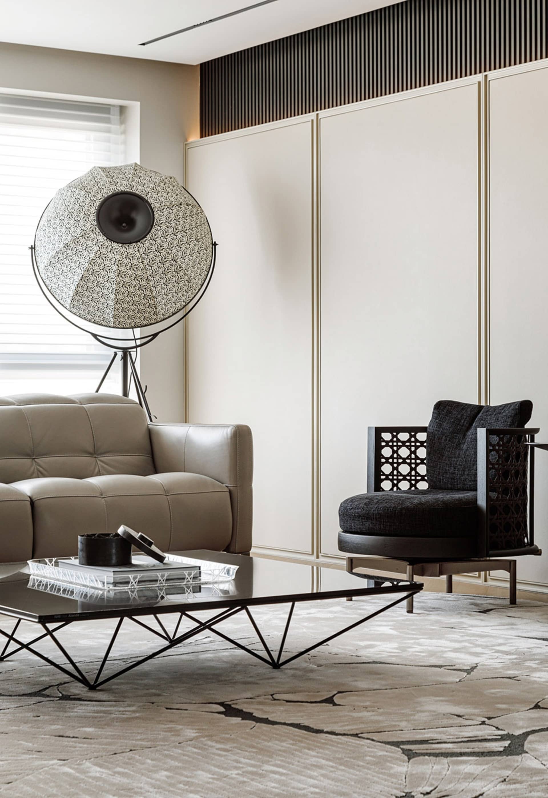 Contemporary living room featuring modern furniture, a unique floor lamp, and minimalist design elements.