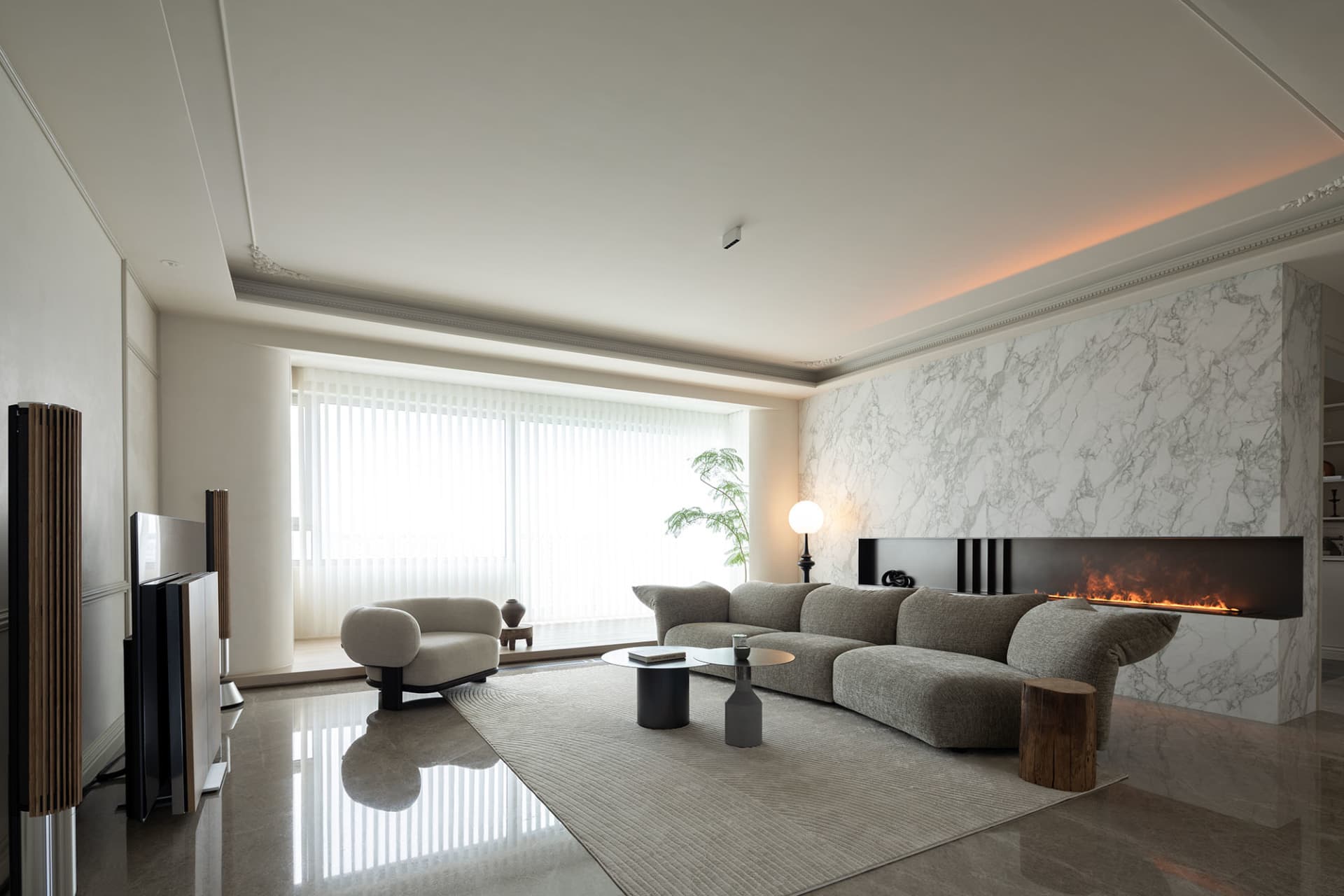 Minimalist living room with marble accent wall and furniture.