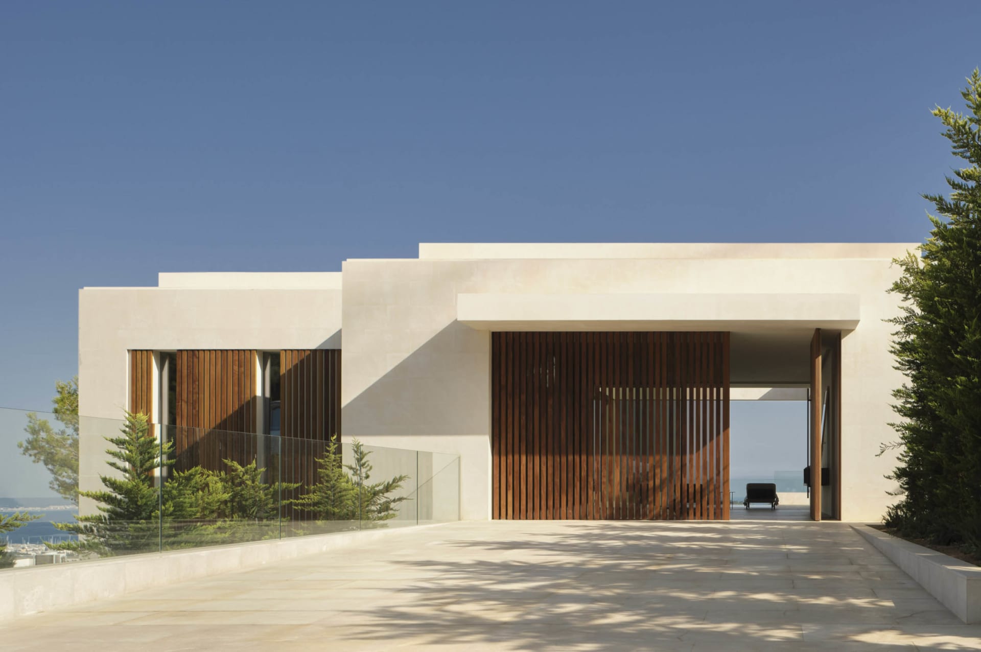 Modern residential building with concrete and wooden features.