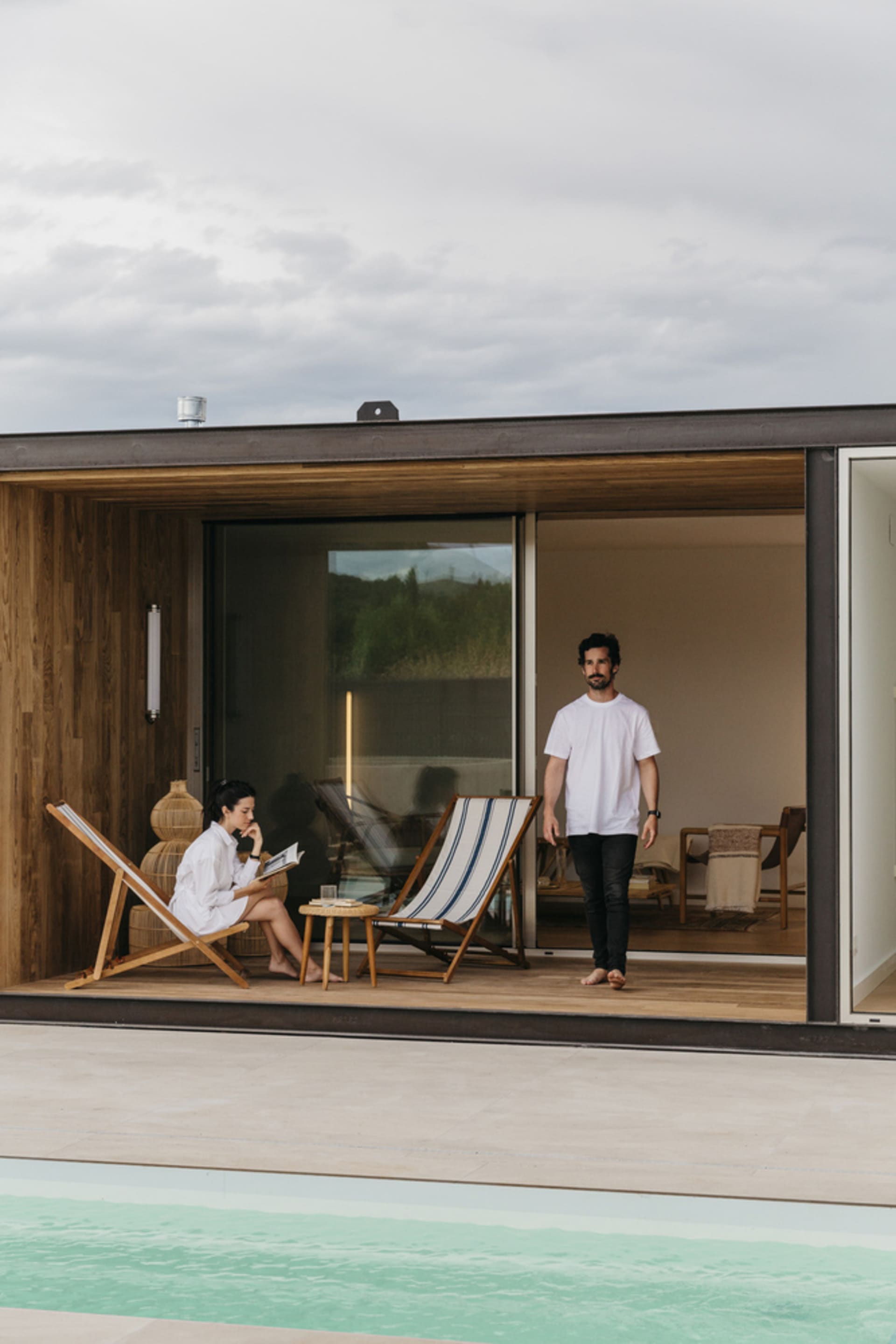 A modern terrace with wooden construction and a pool.