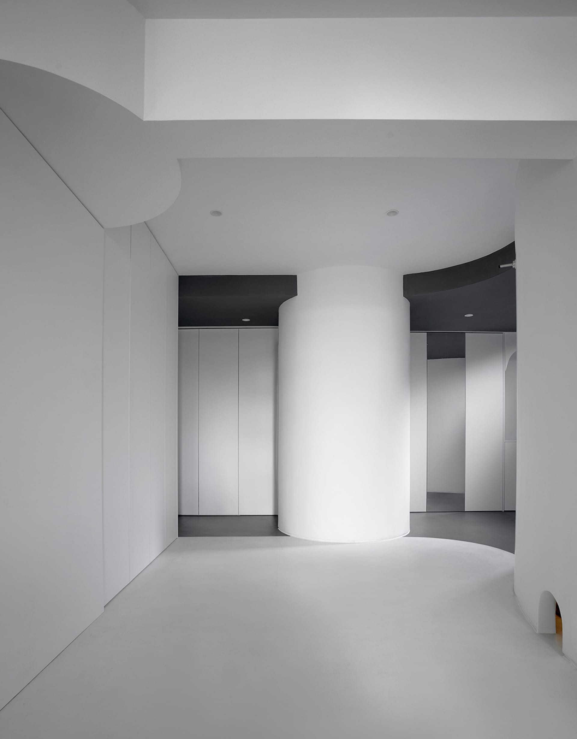 A minimalist interior featuring white walls and floor.