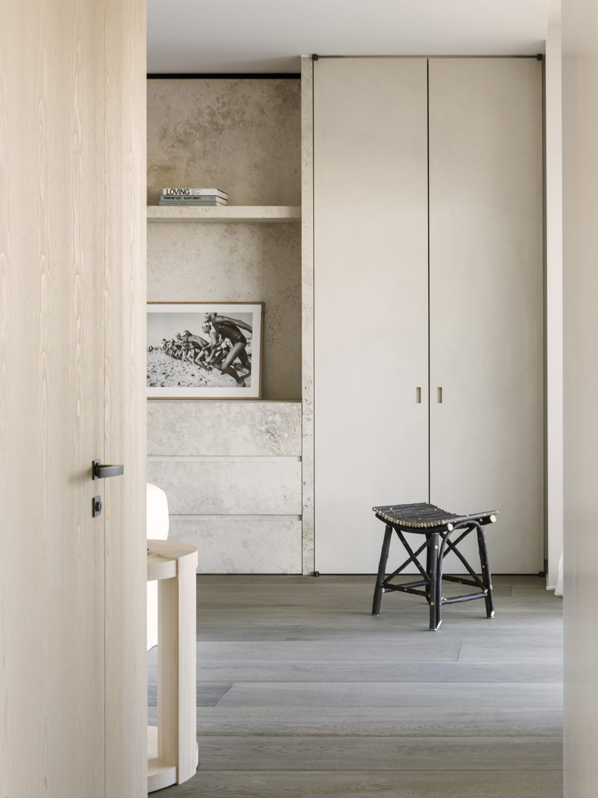 A modern bedroom featuring concrete walls and a minimalist design.