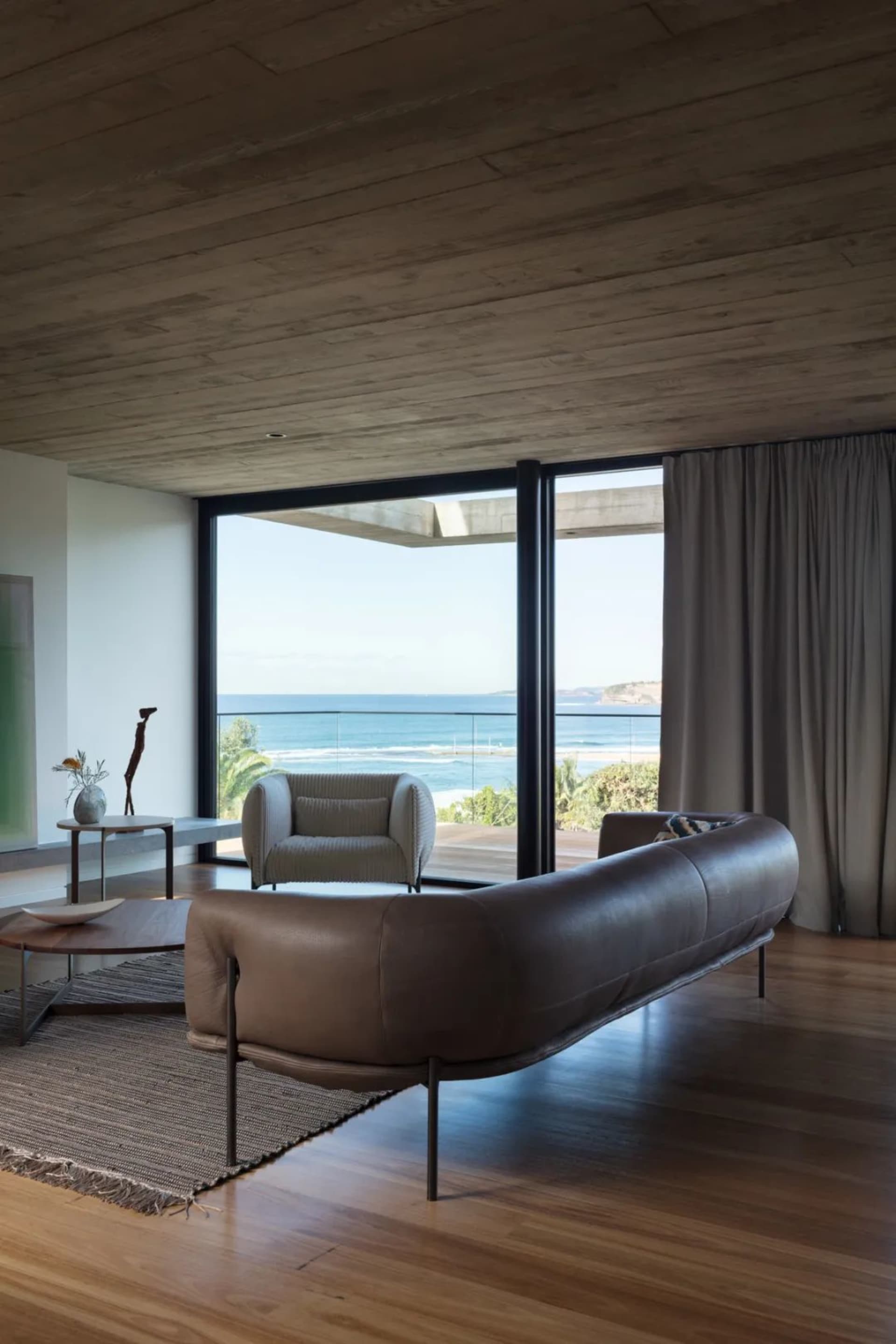 Contemporary living room featuring modern leather furniture and concrete ceiling