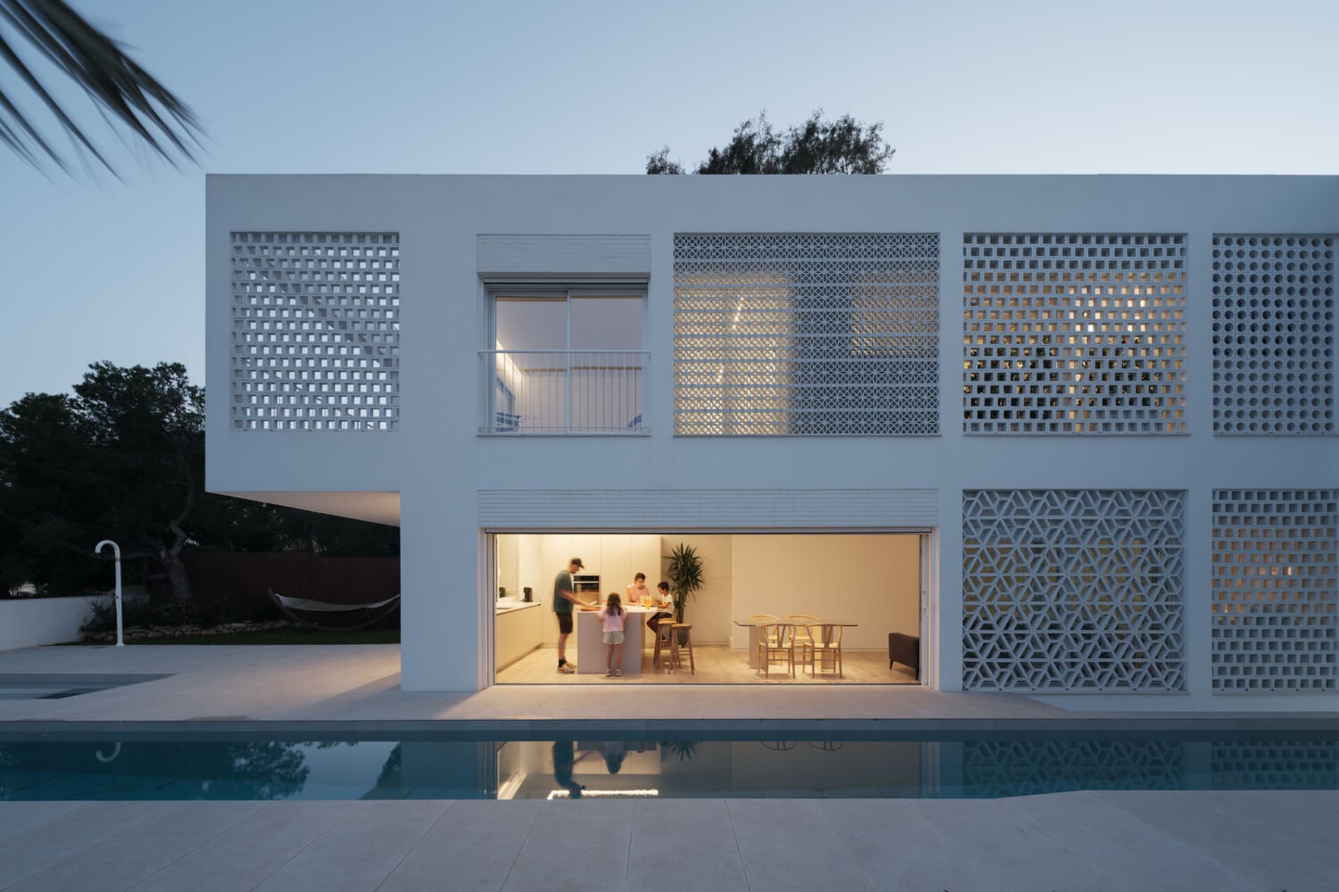 An image of a modern residential home featuring lattice panels on the exterior.