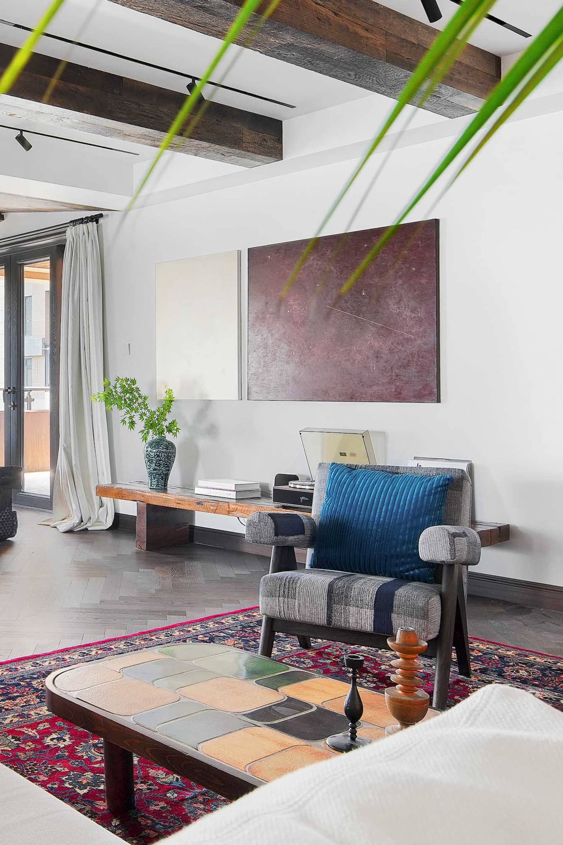 A living room featuring industrial design elements such as wood, ceramic tiles, and fabric.
