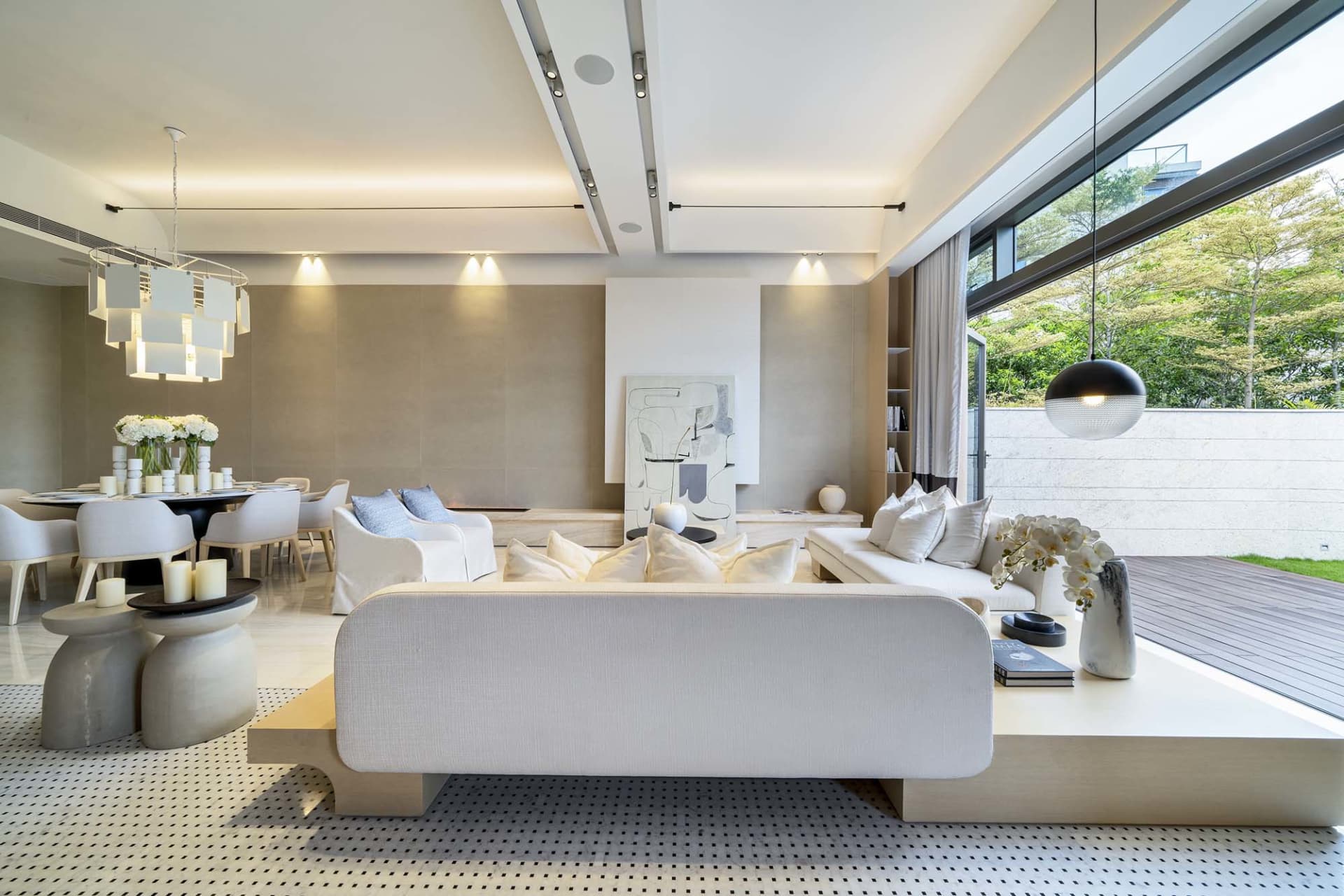 Modern minimalist living room with sleek white furniture, a unique jack-leg stool arrangement, and elegant wall art incorpora