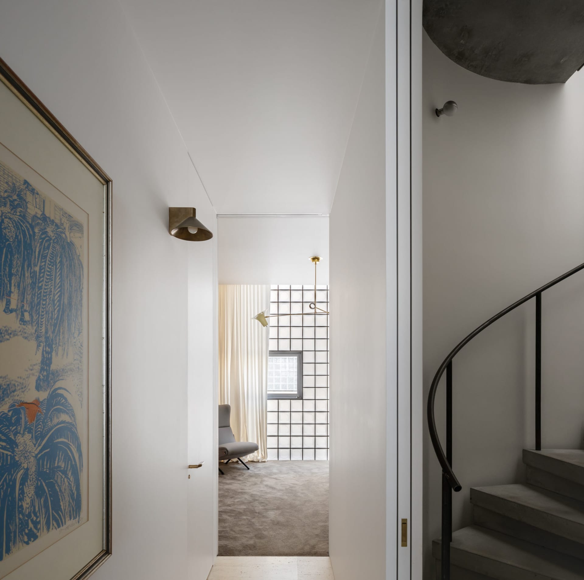 A modern residential entryway featuring concrete and glass material