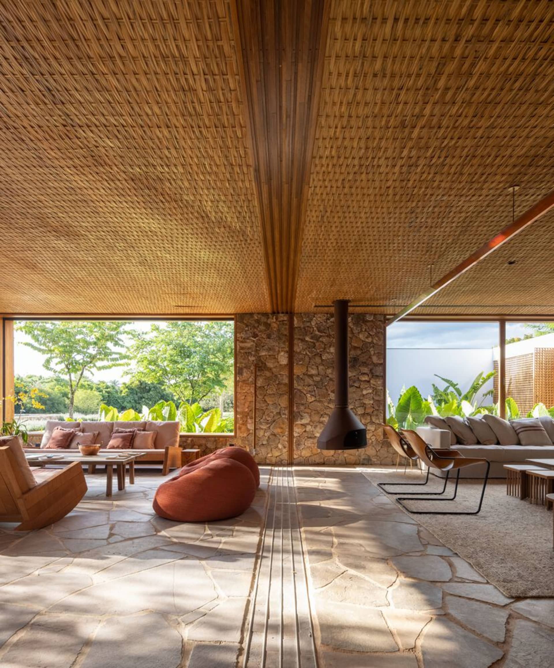 Modern living room with wooden ceiling and stone floor