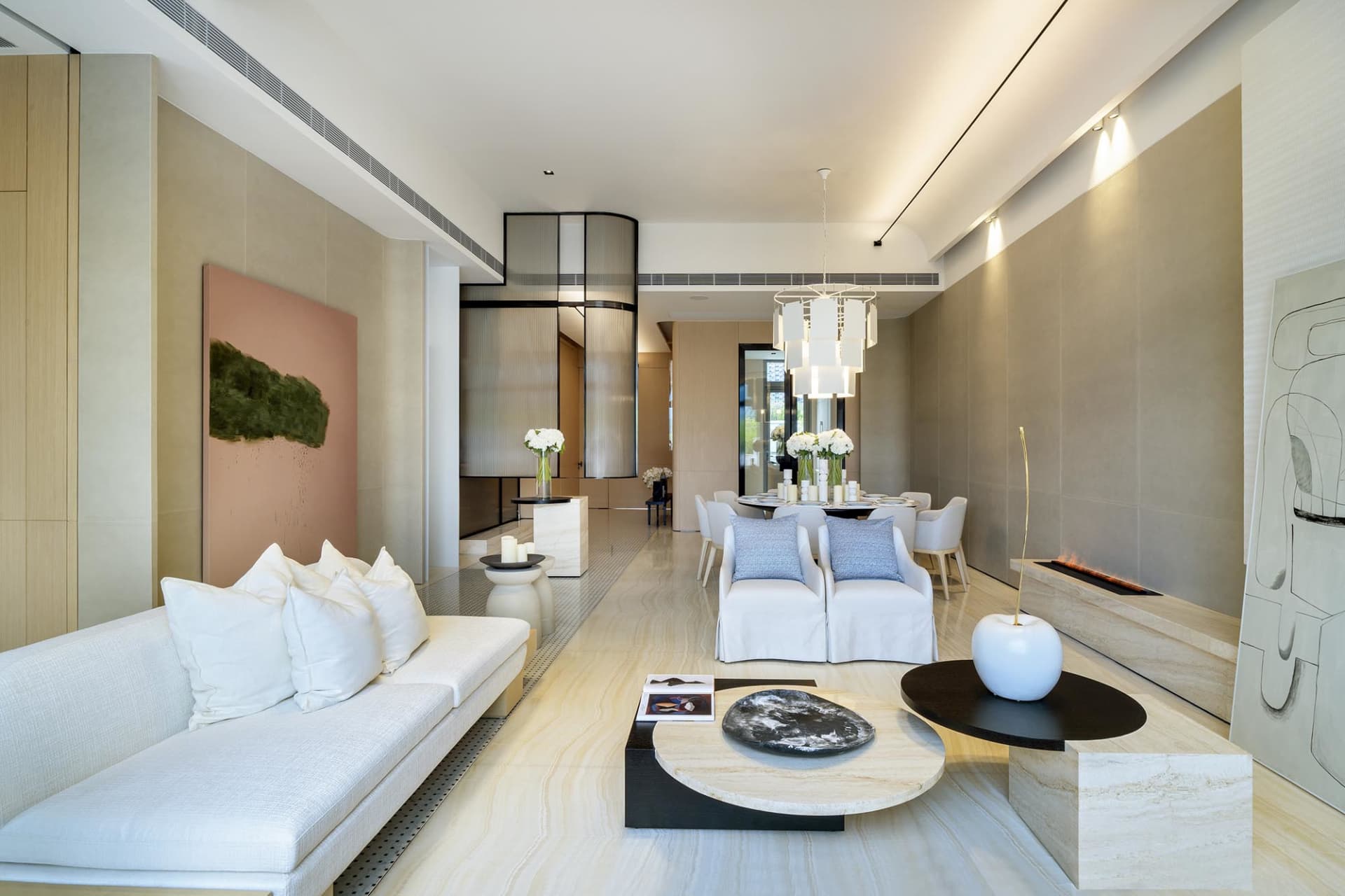 A stylish and contemporary living room featuring marble elements and modern furniture.