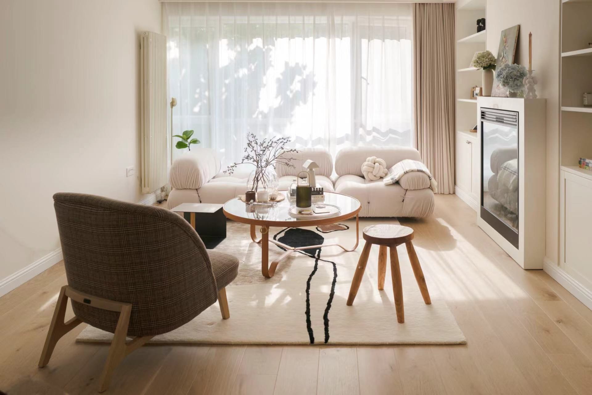 A cozy wooden living room with glass decor and plush seating arrangements.