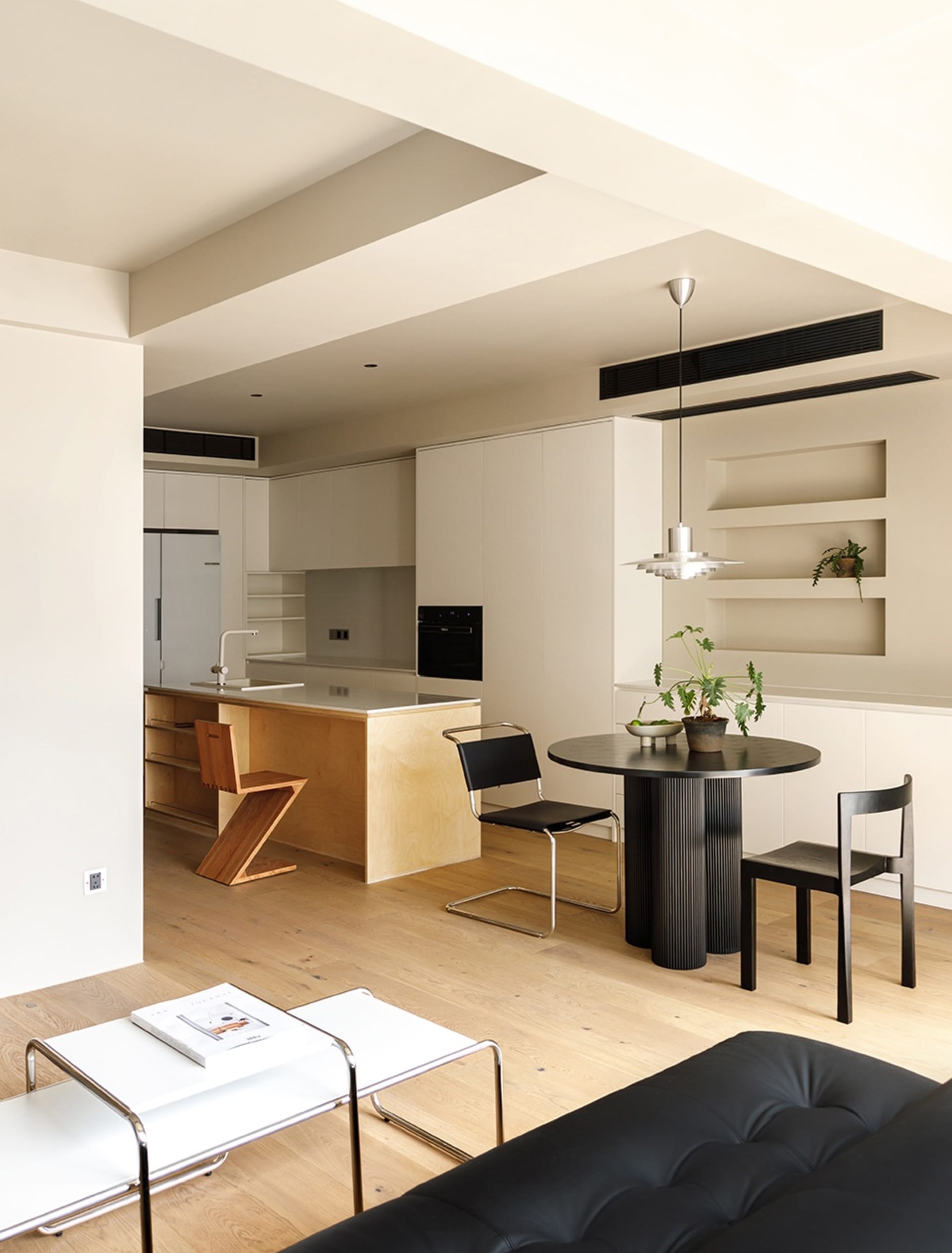 A modern kitchen with wooden finishes and minimalist design elements