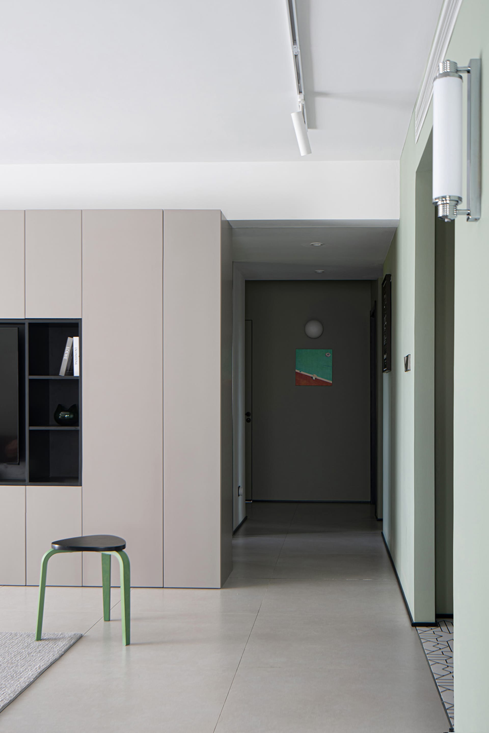 Modern residential hallway with minimalist design and painted cement subfloor.