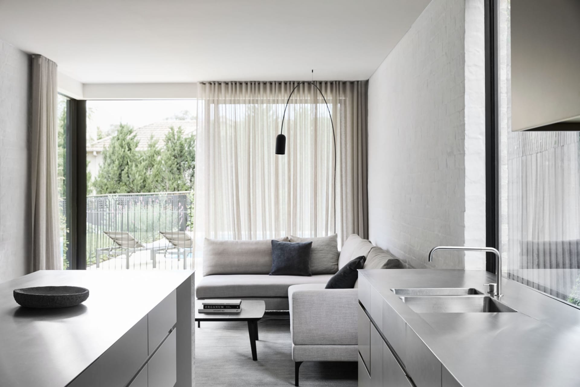 Modern living room with concrete flooring and minimalist design.