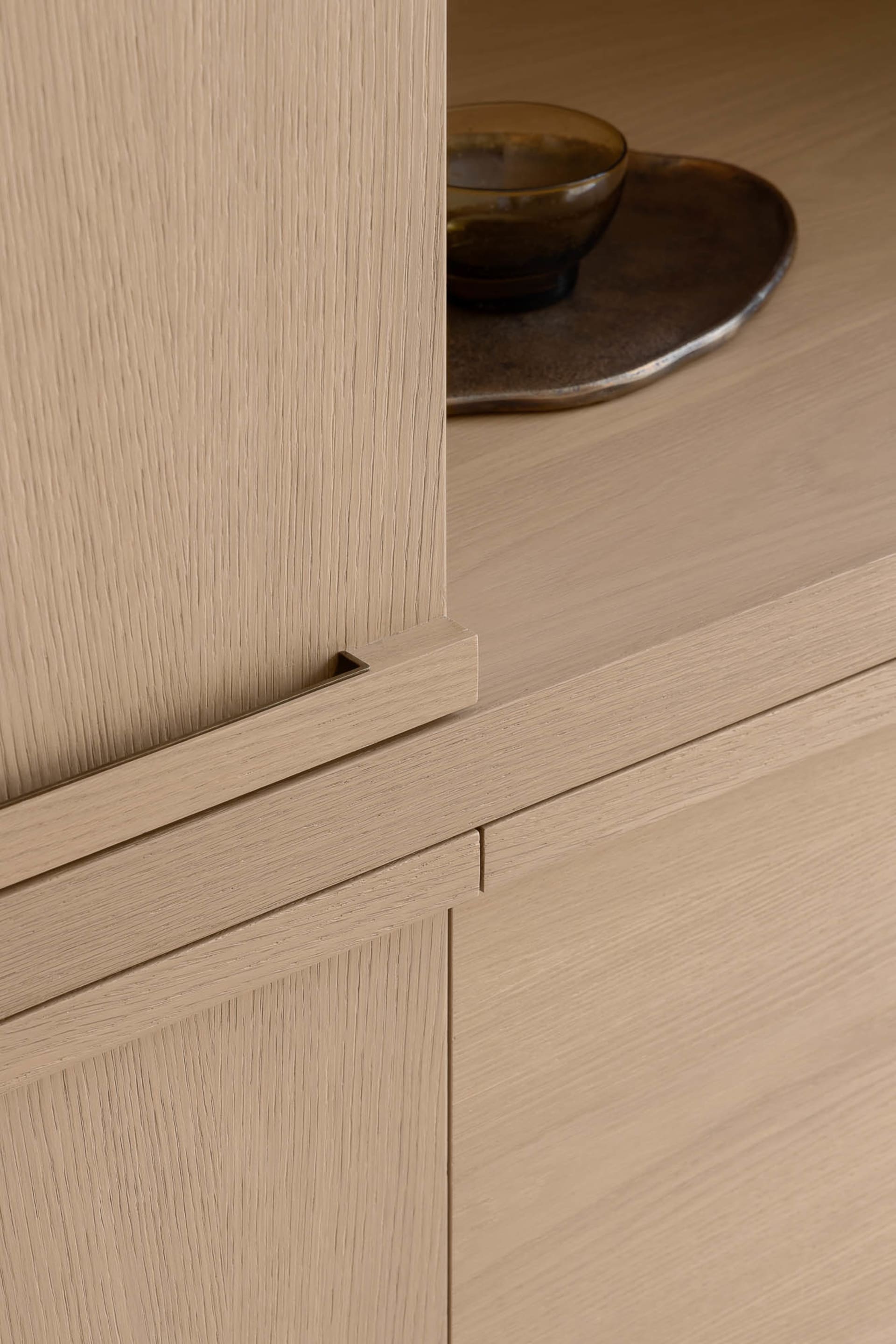 A minimalist sideboard crafted from wood, featuring clean lines and simple design.