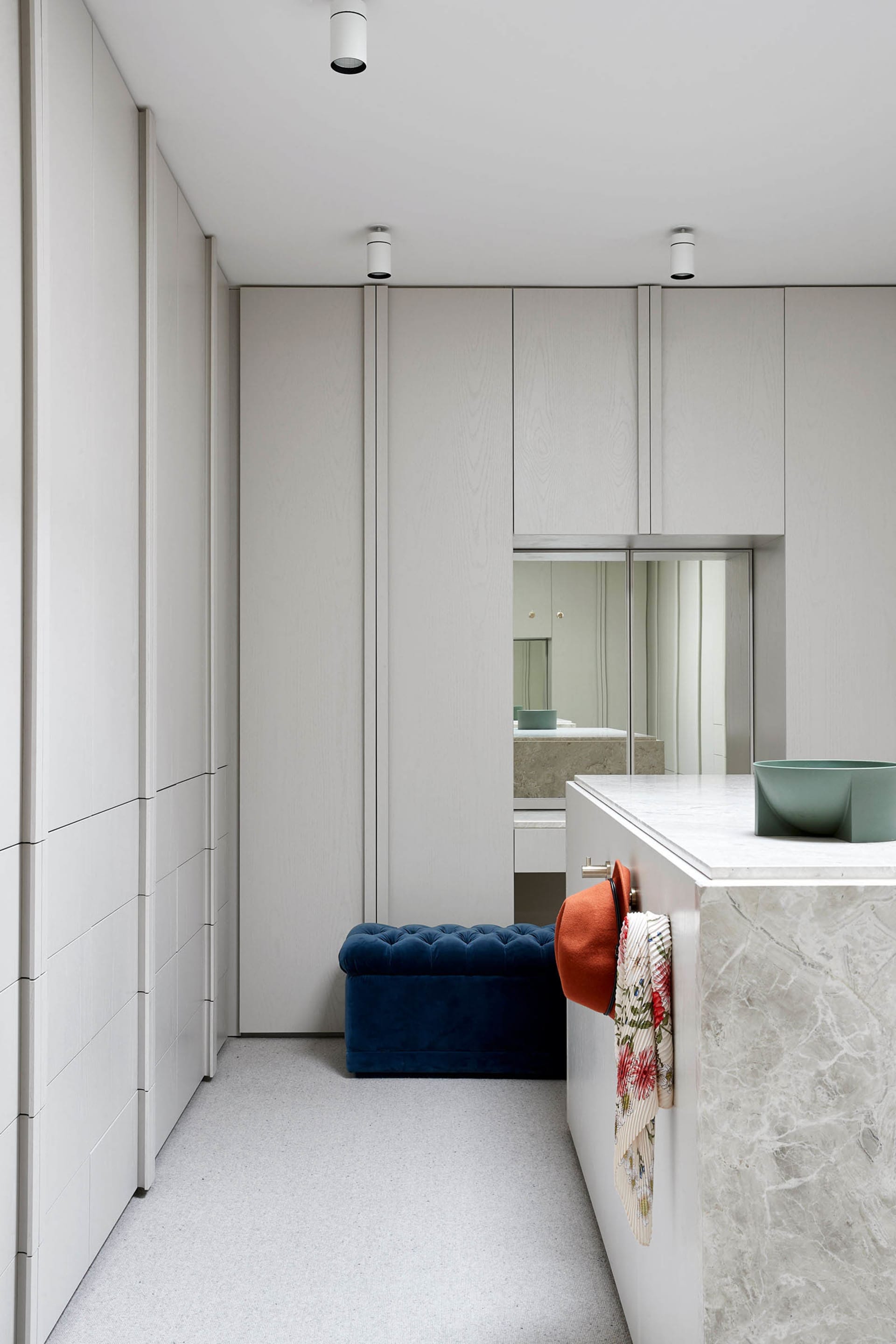 Modern marble closet interior with minimalist design features and storage solutions.