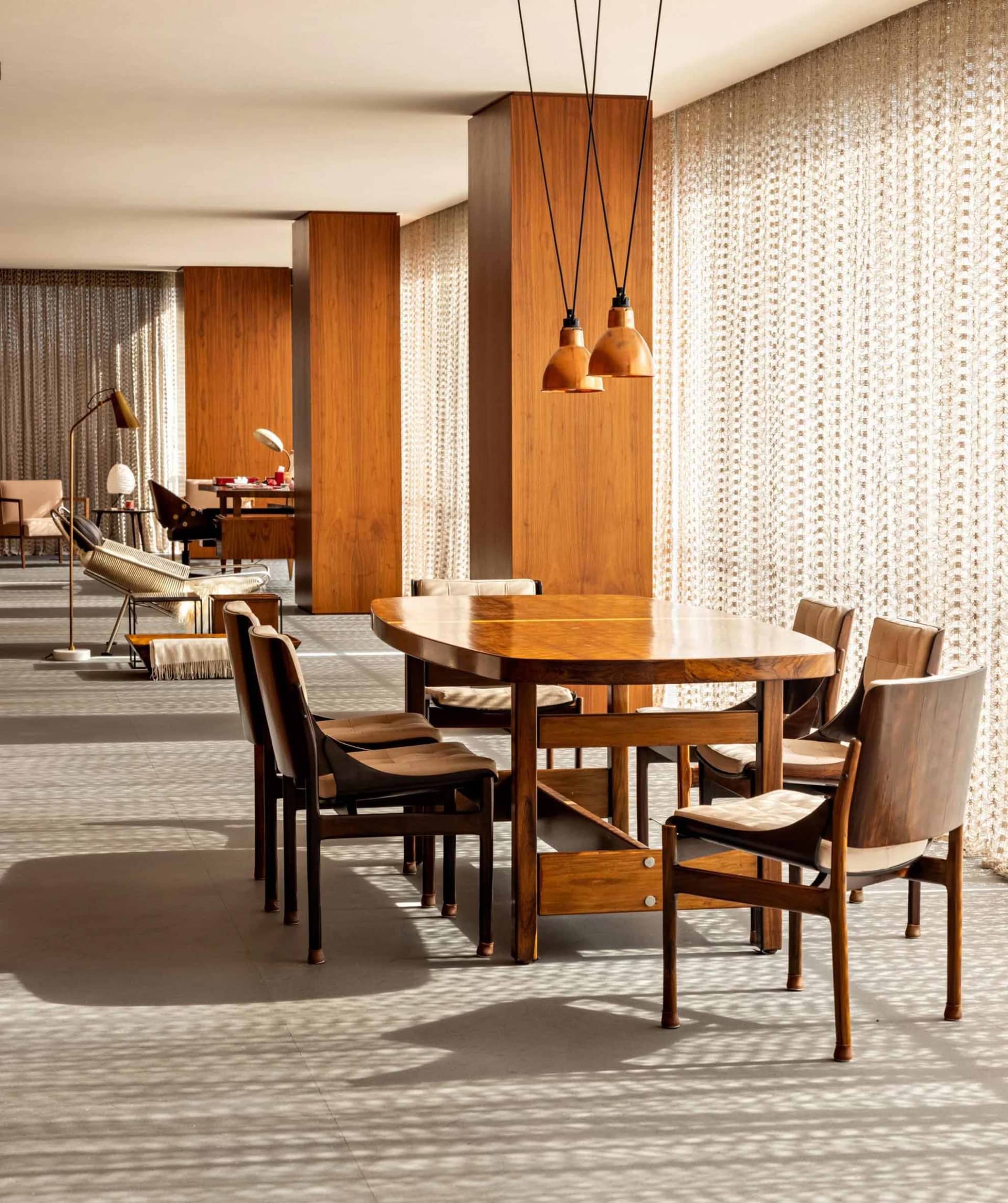 A modern dining room with a wooden table and chairs.