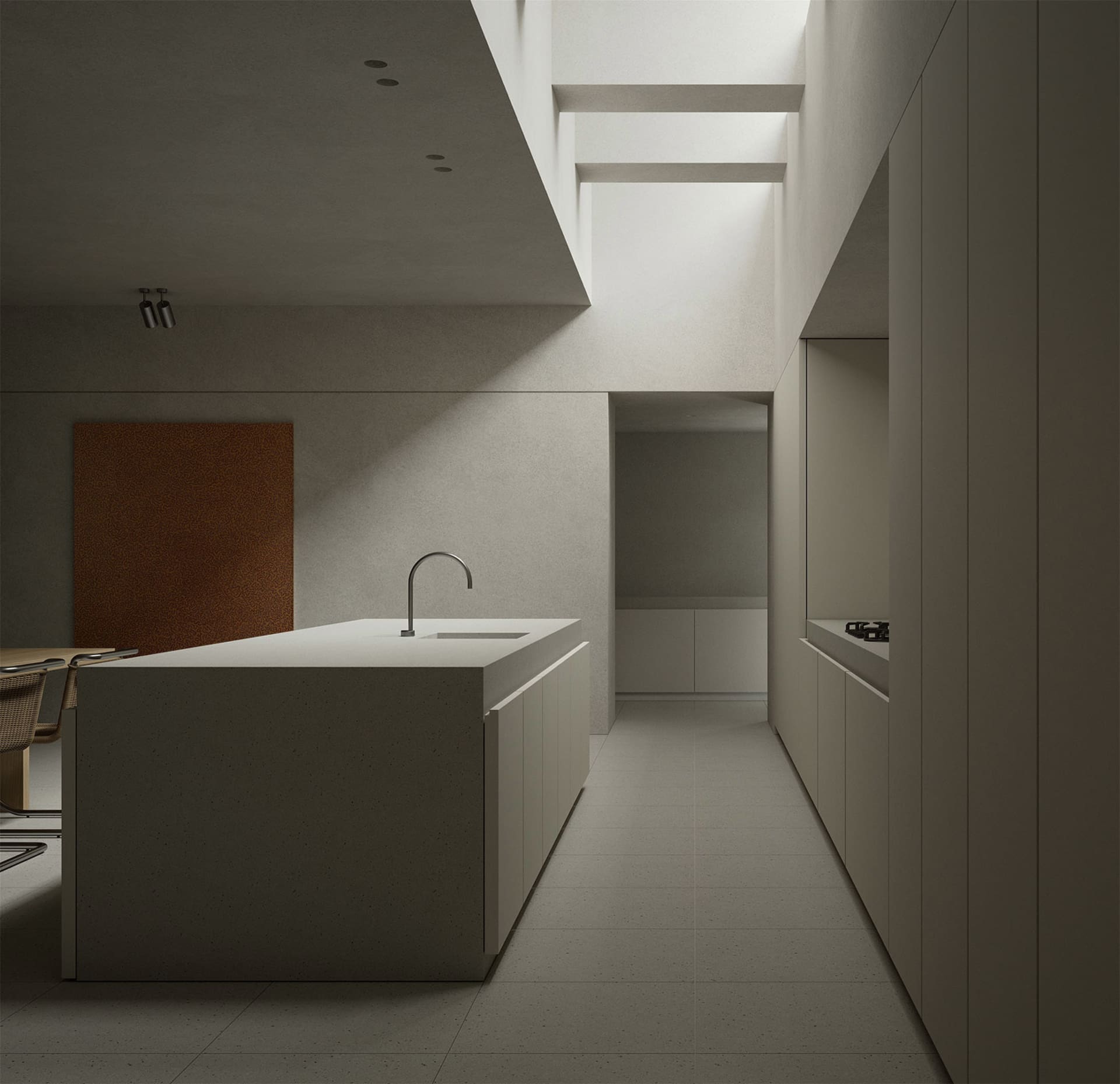 A minimalist kitchen with a concrete island and white cabinets.