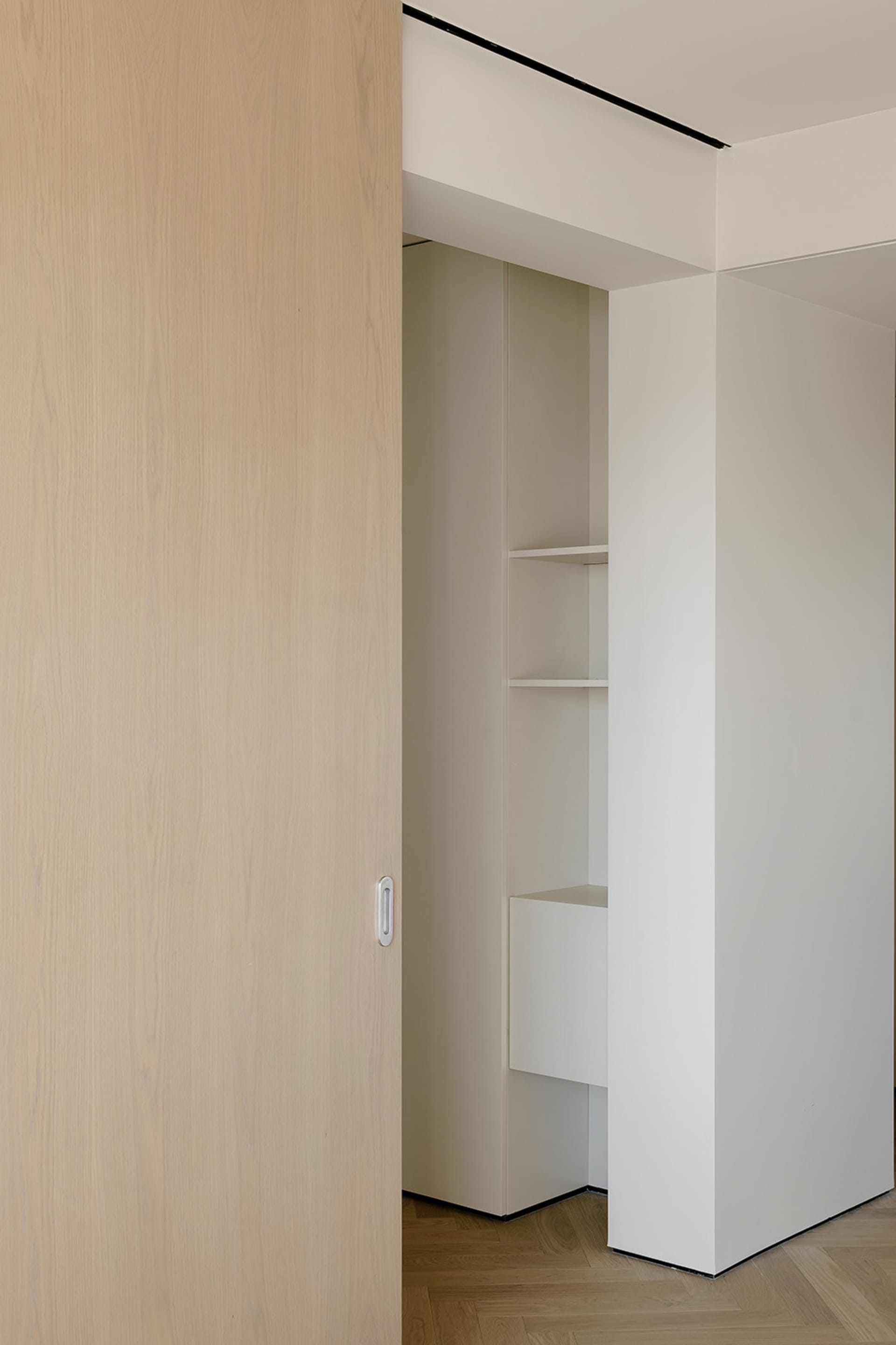 Modern interior design featuring wooden closet storage with shelves and drawers.