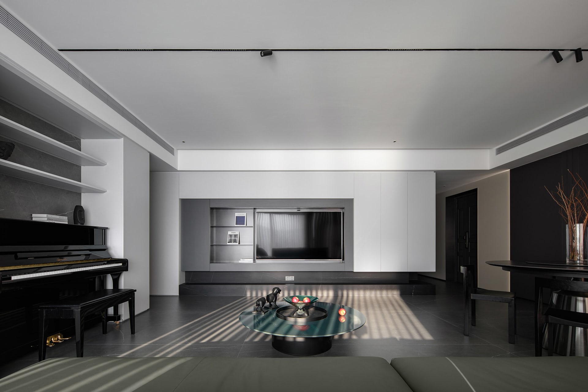 A modern living room featuring a black and white color palette, with minimalist furniture and metallic accents.