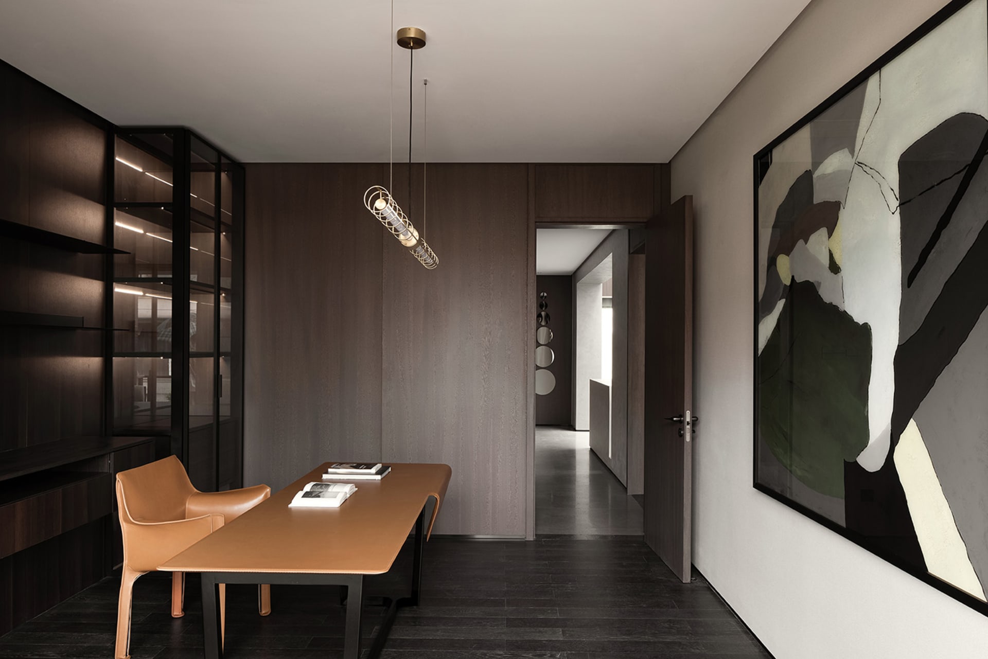 A modern home office featuring a sleek, minimalist desk with a leather surface, designed for comfort and functionality.