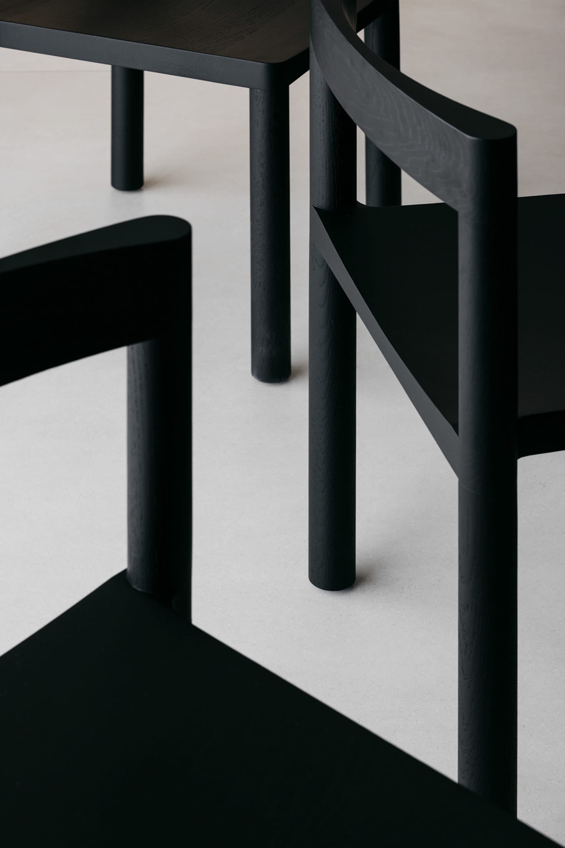 Detailed view of minimalist black wood furniture with clean lines and simple design.