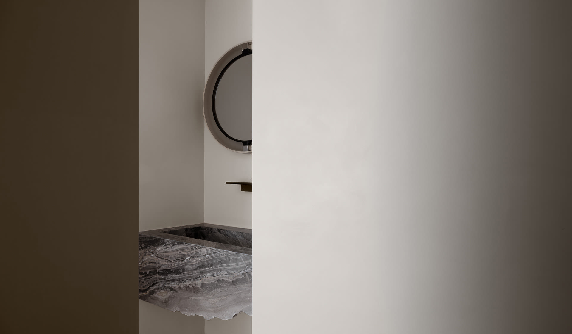 Modern bathroom featuring a marble sink with minimalist design elements.
