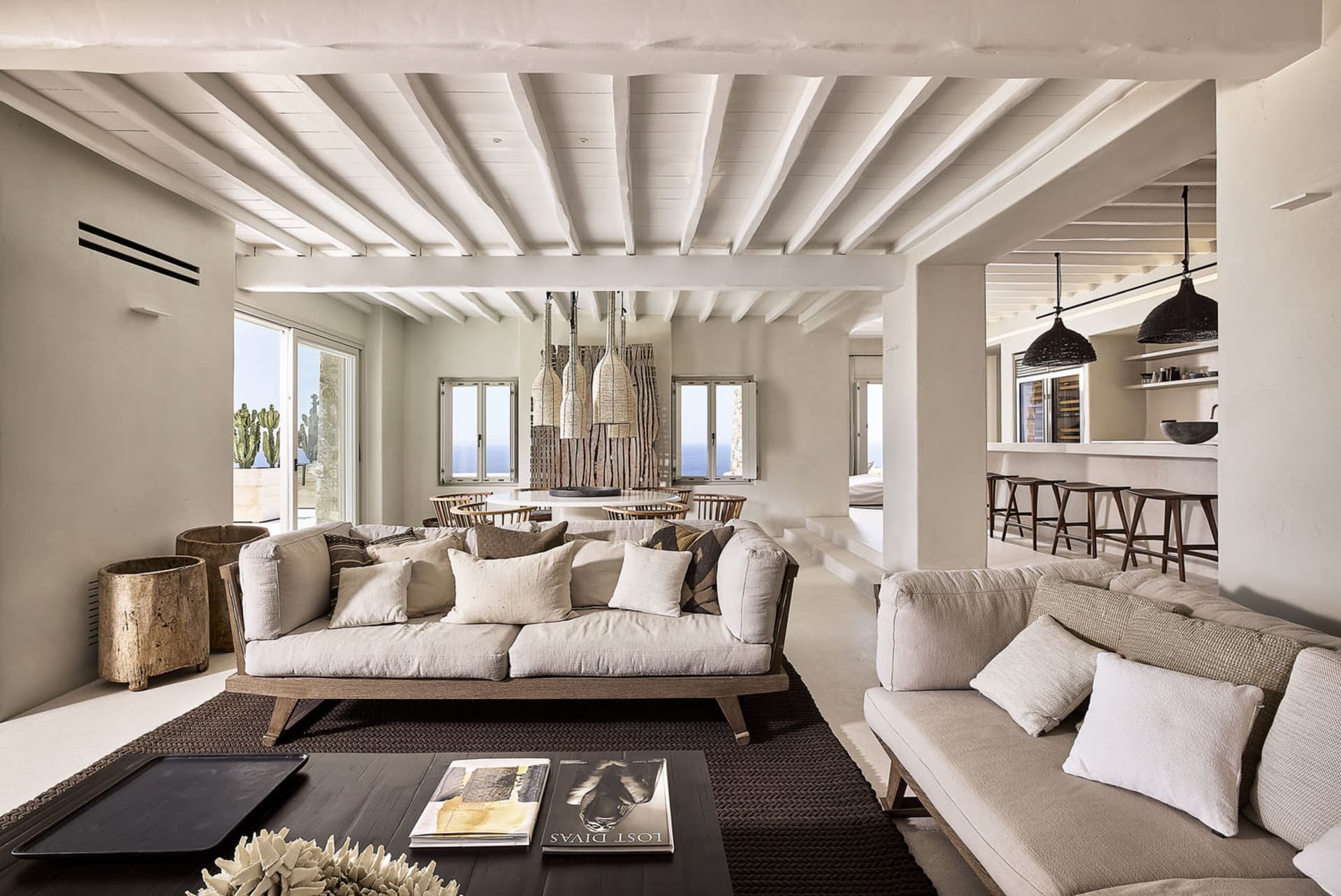 A spacious, modern living room with neutral-toned furniture and decor.