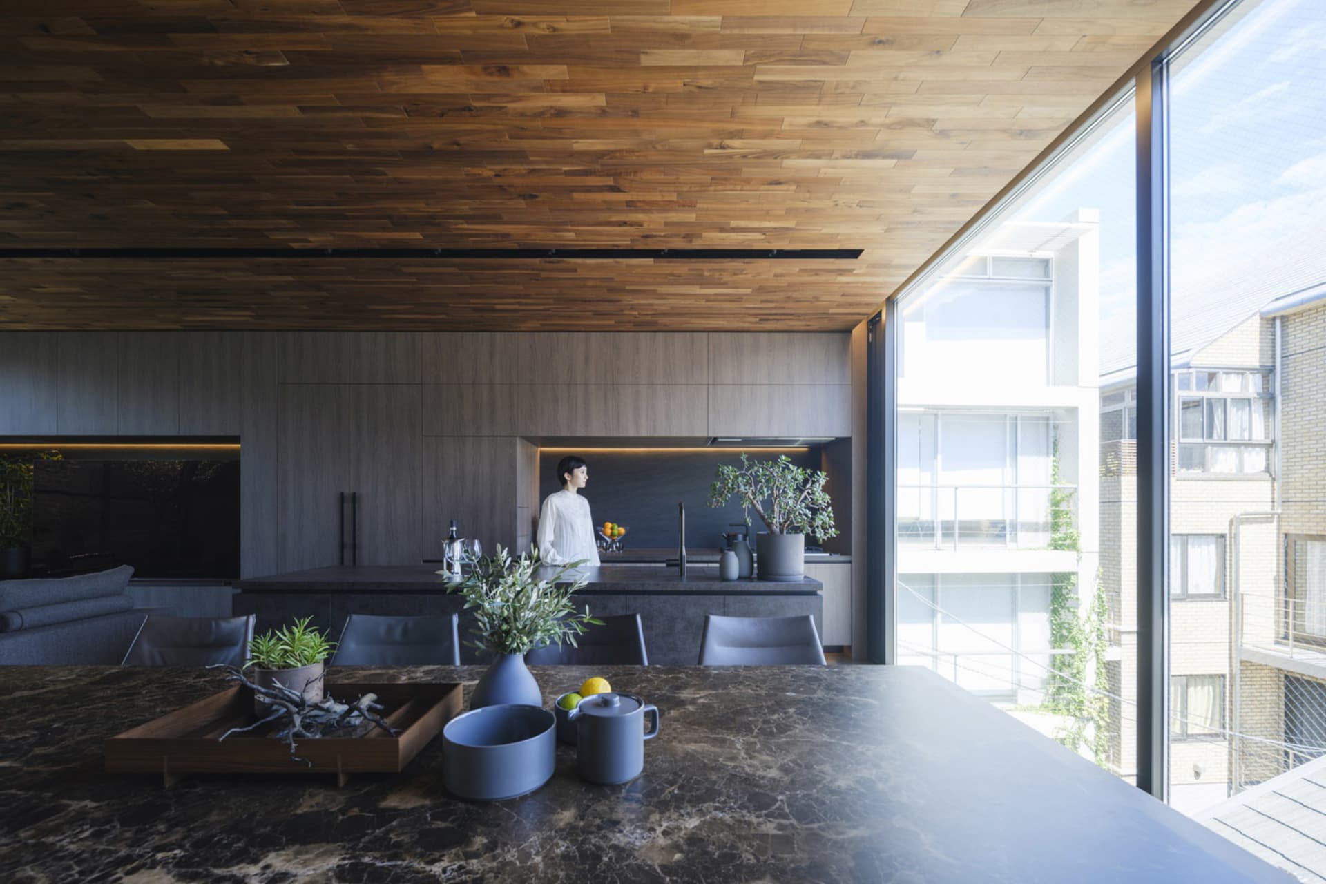 Modern residential kitchen featuring a marble countertop and minimalist design.