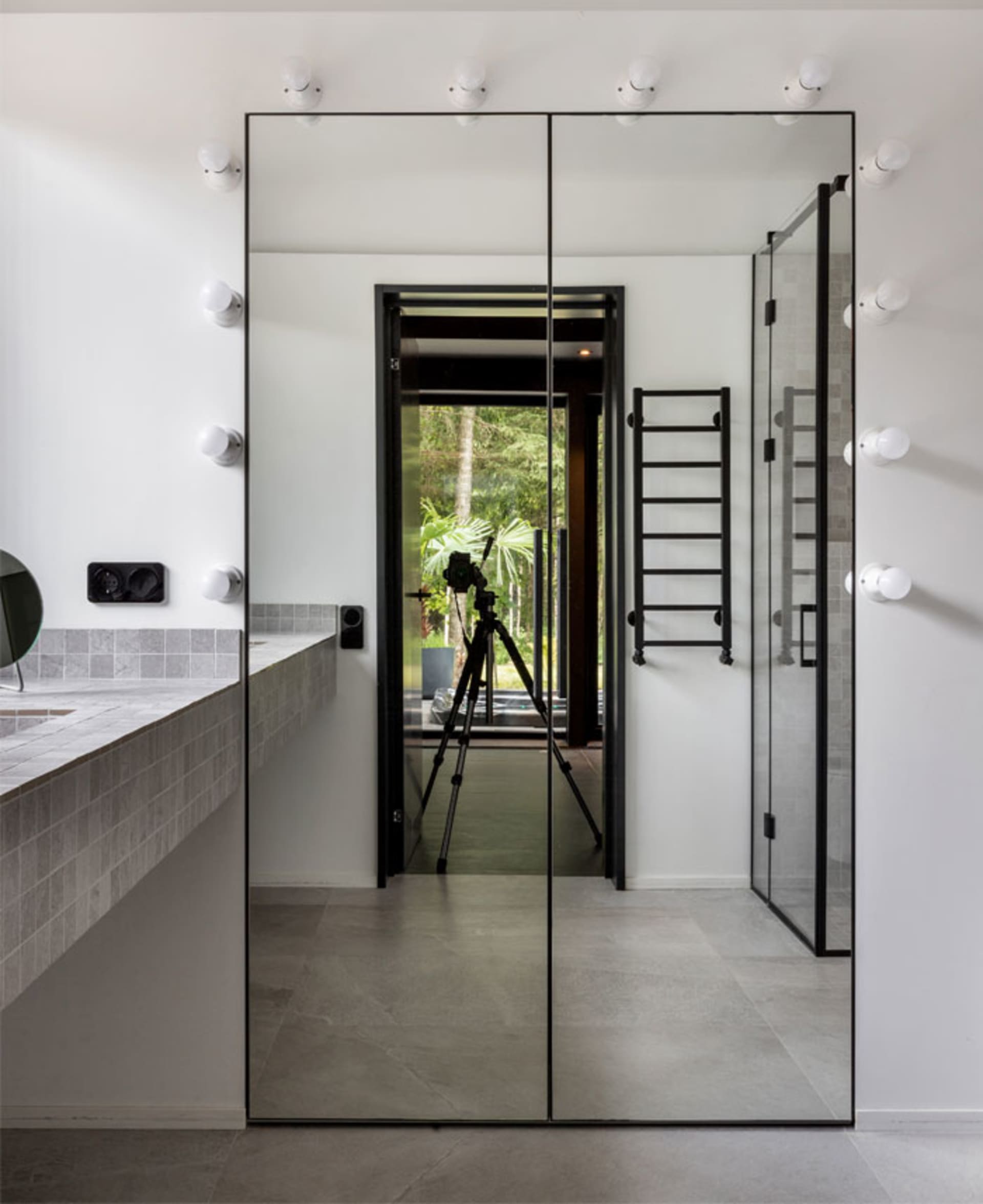 Modern bathroom interior with glass and concrete surfaces, minimalist design