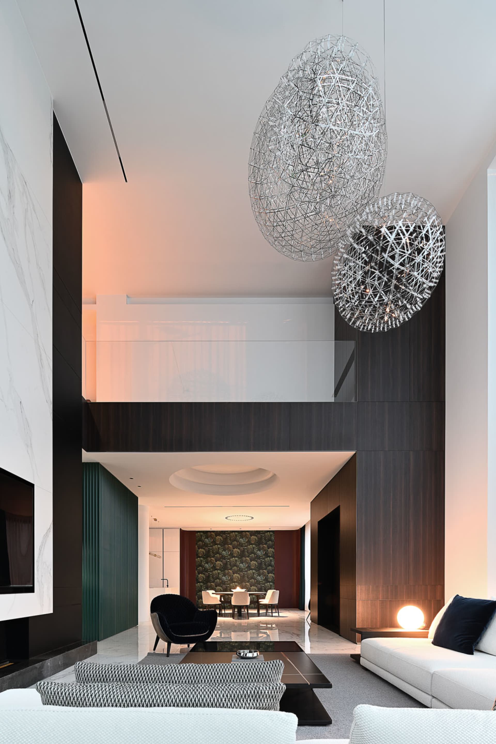 Modern living room with steel, wood, and marble elements.
