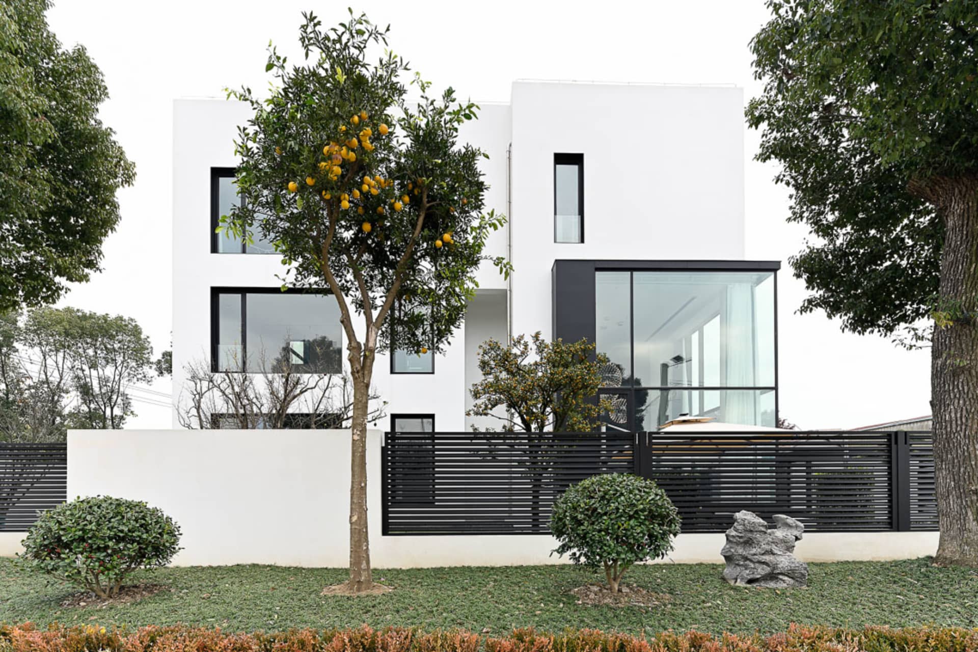A modern building with large glass windows and white walls.