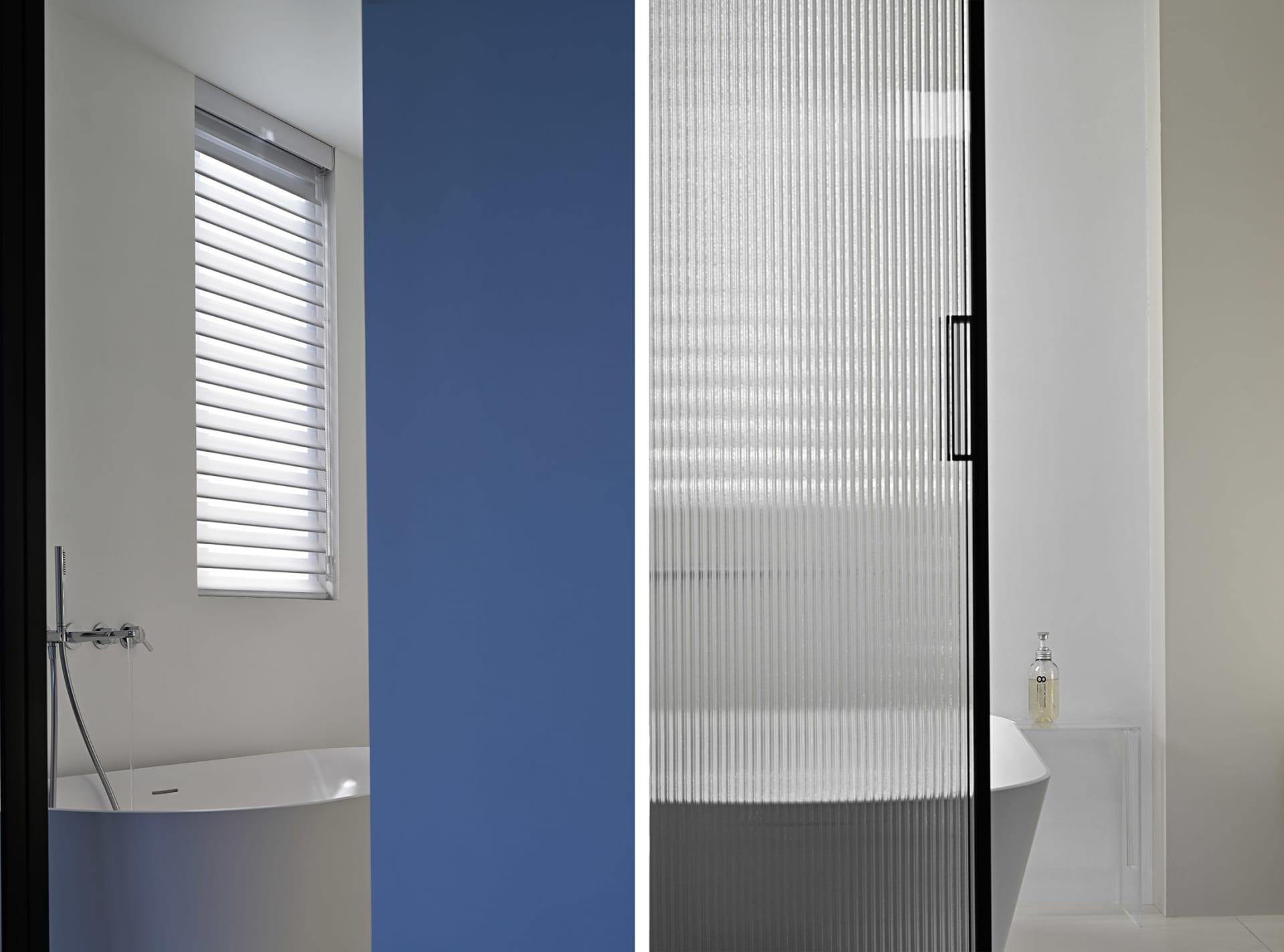 A modern bathroom featuring a glass partition and blue accent wall
