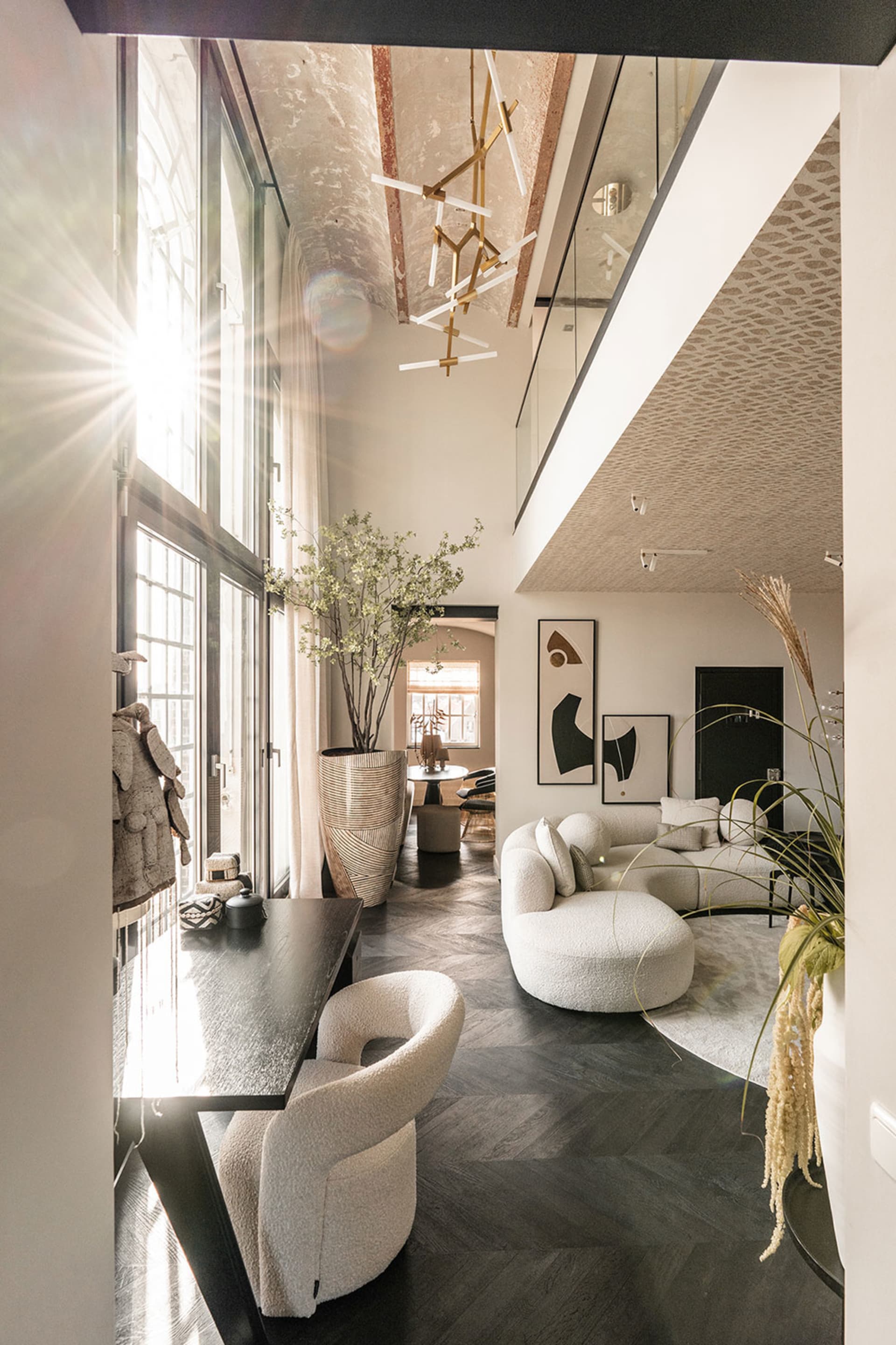 A modern, minimalist living room with contemporary furniture and glass walls.
