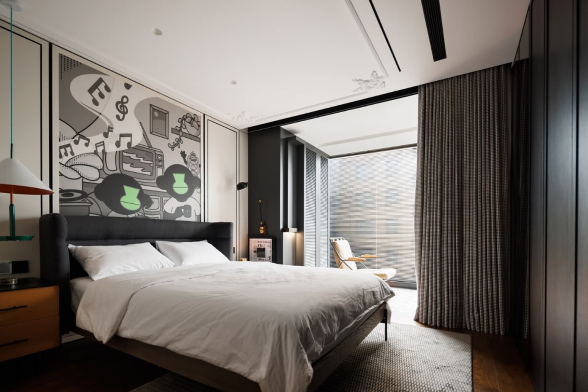 A modern bedroom featuring textiles and glass elements.