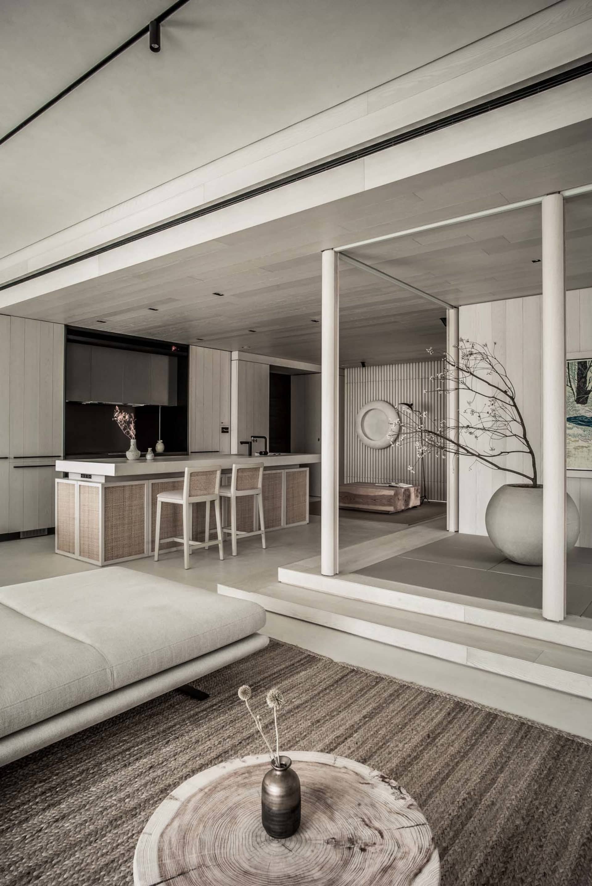 A modern interior living room with minimalist design and wooden materials, featuring a sofa, coffee table, and decorative vas
