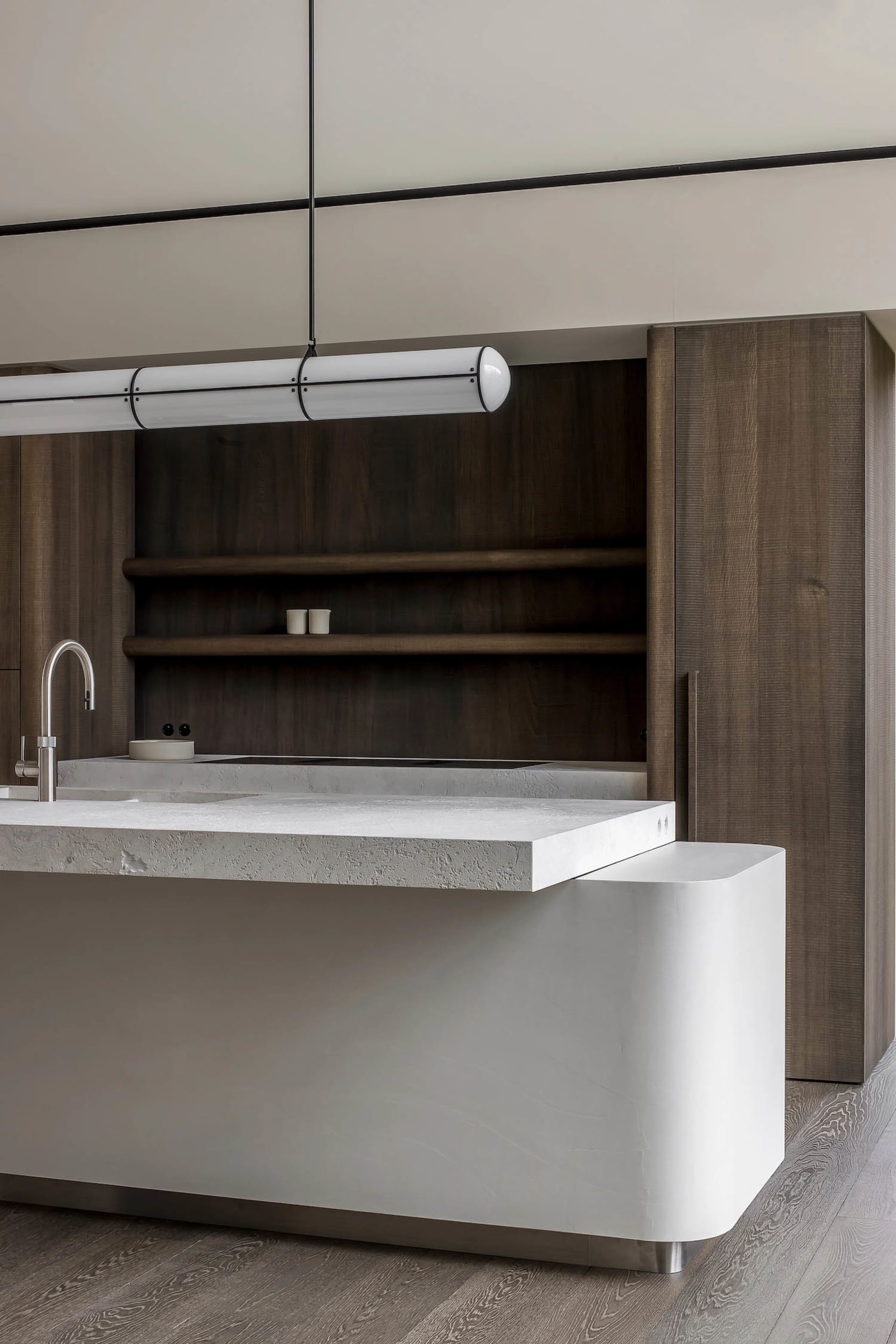 Modern kitchen with clean lines, concrete countertops, and wooden shelves.
