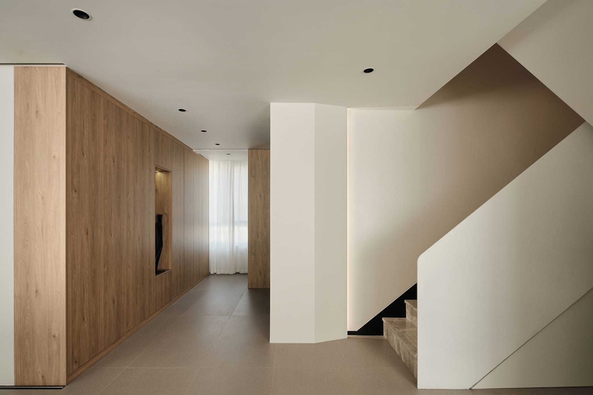 Modern staircase with wooden walls and concrete steps in a minimalist interior design.