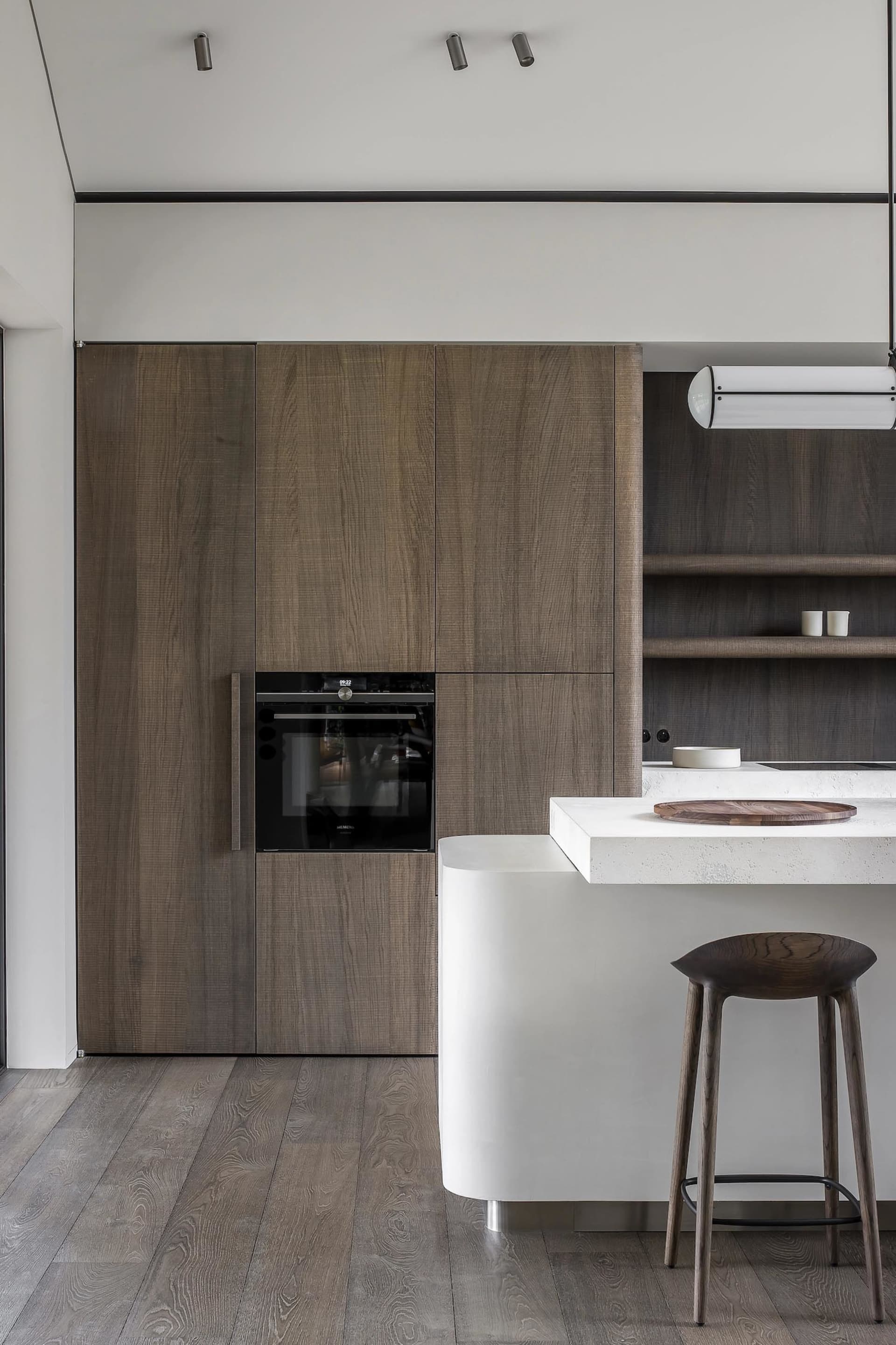 A modern kitchen with wooden cabinets and a white countertop.