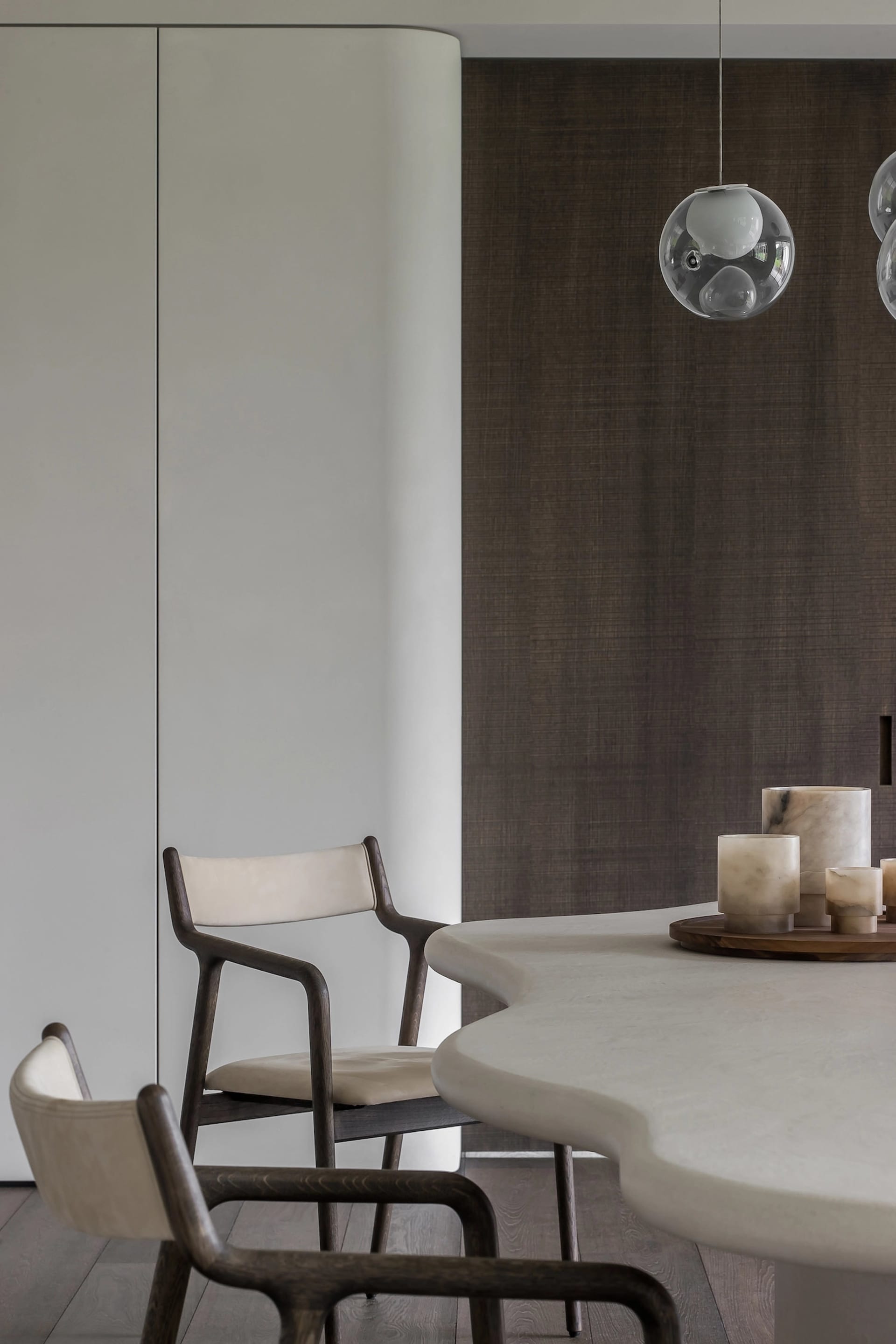 Modern dining room featuring marble and concrete elements.