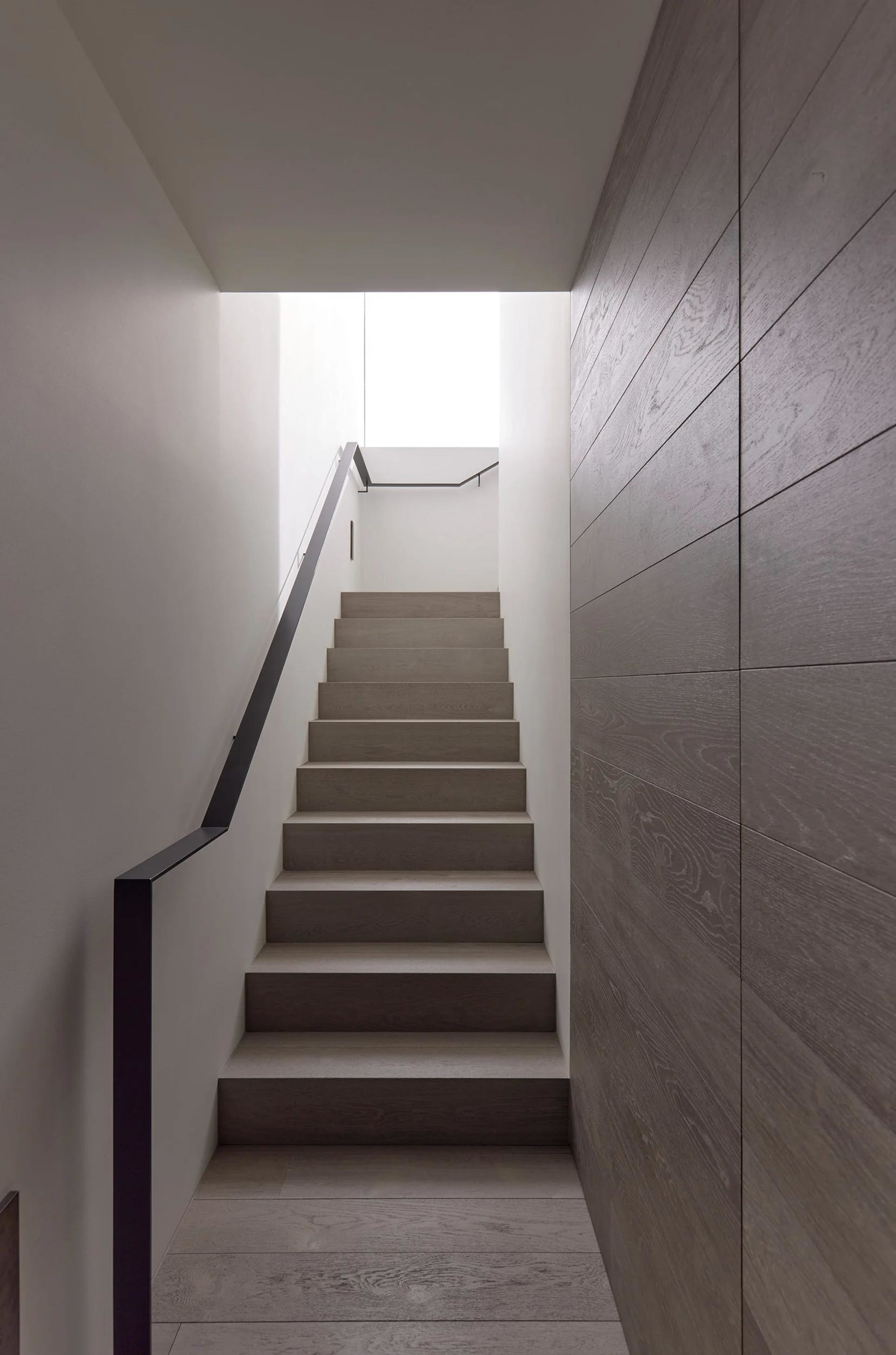 Modern staircase with wooden steps and metal railings