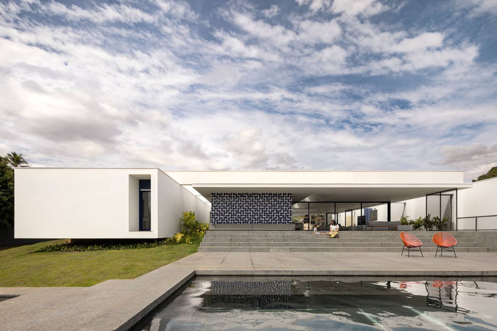 Modern residential architecture with concrete exterior and a swimming pool.