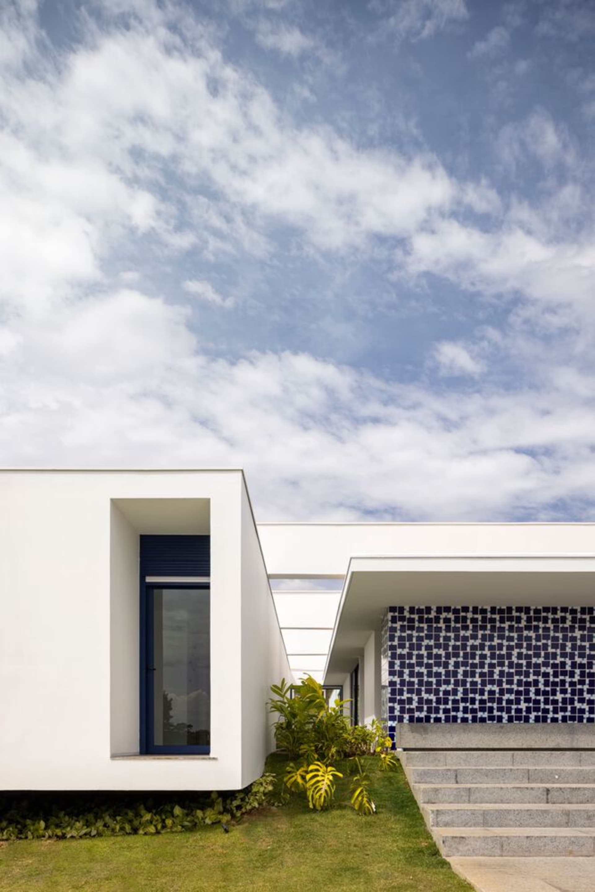 Modern house with a white exterior and gray stairs