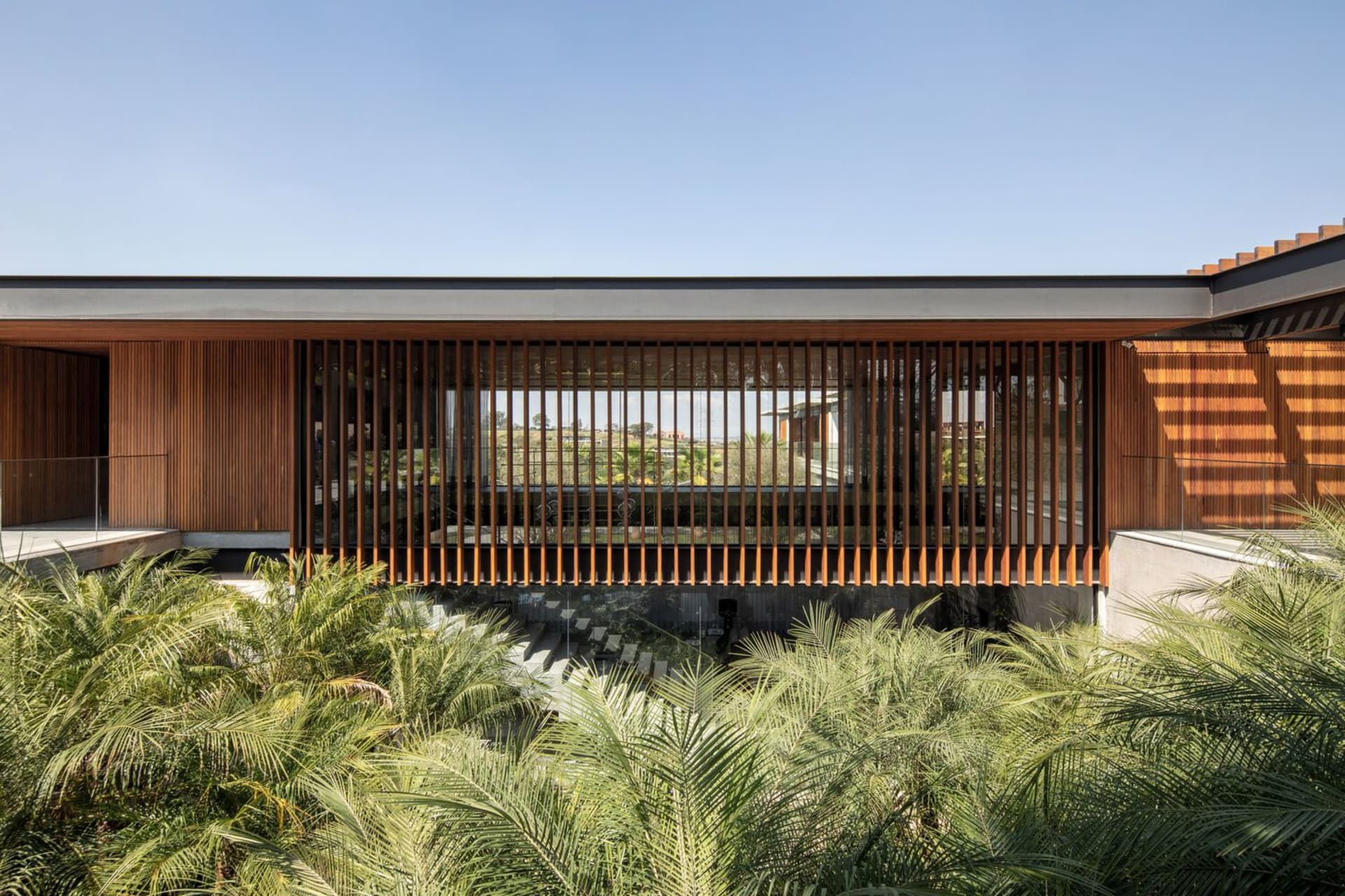 A modern architectural exterior featuring a wooden facade with vertical slats.