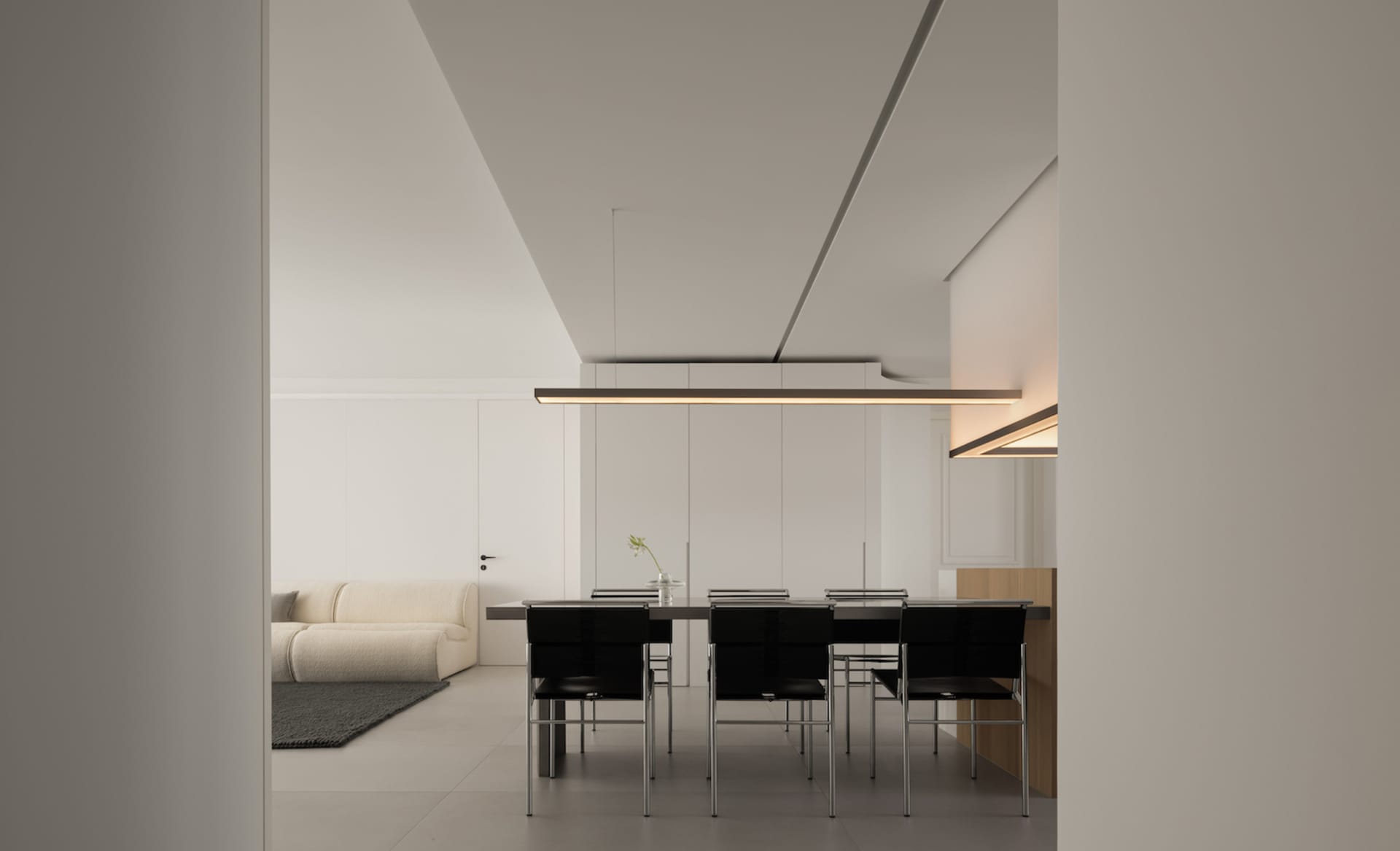 Modern minimalist living room with clean lines, white walls, and contemporary furniture.