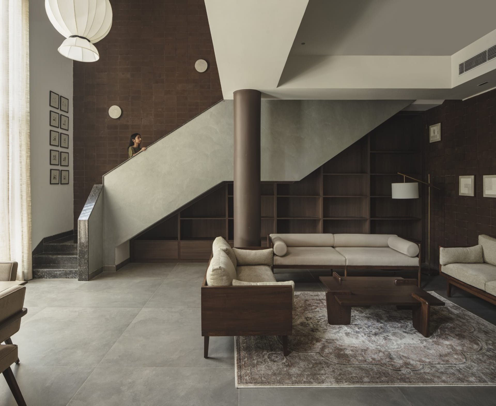 Modern living room featuring concrete walls and wooden furniture.