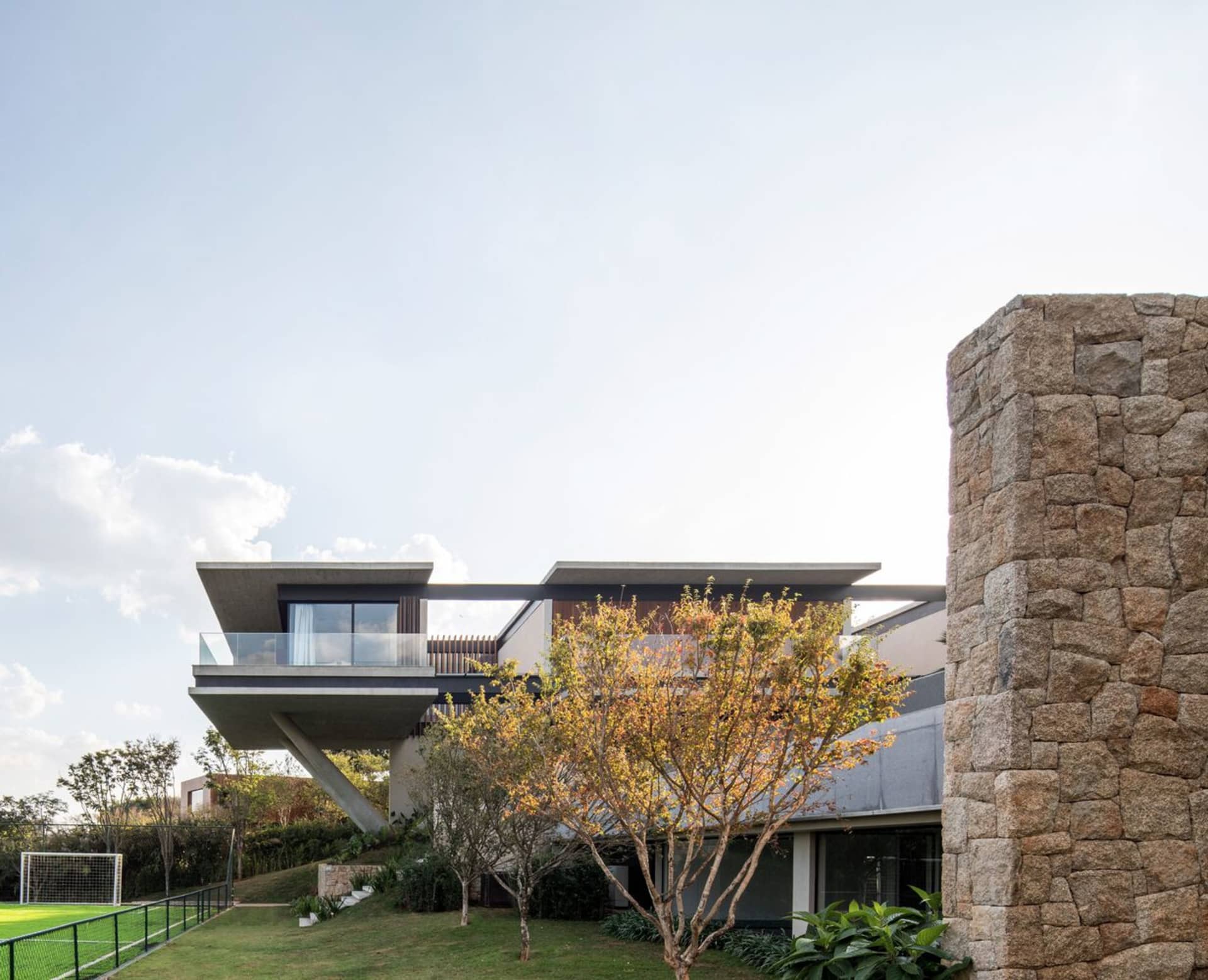 A modern residential home featuring a concrete exterior with a sleek, contemporary design.
