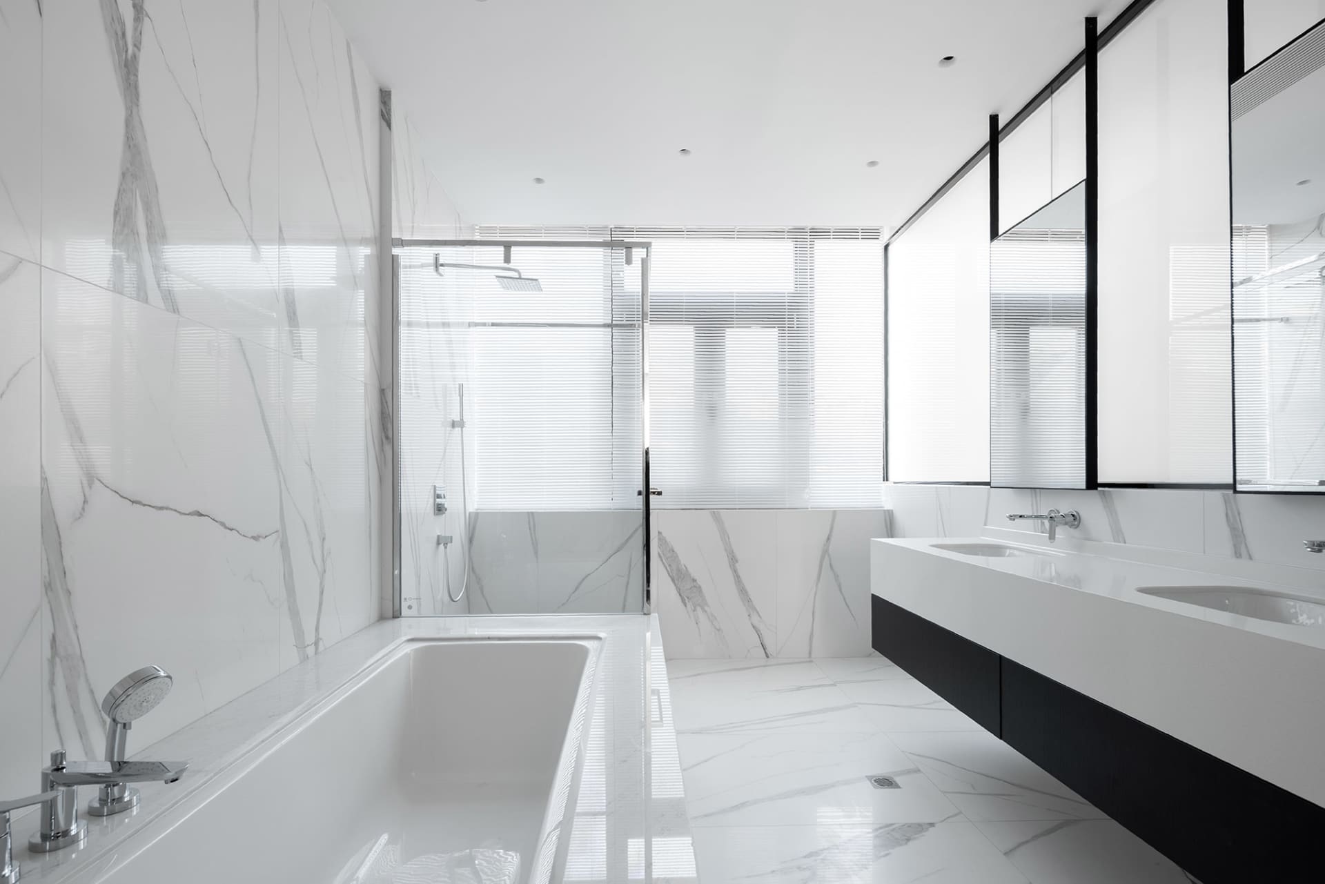Modern minimalist bathroom featuring white marble elements and a sleek design.