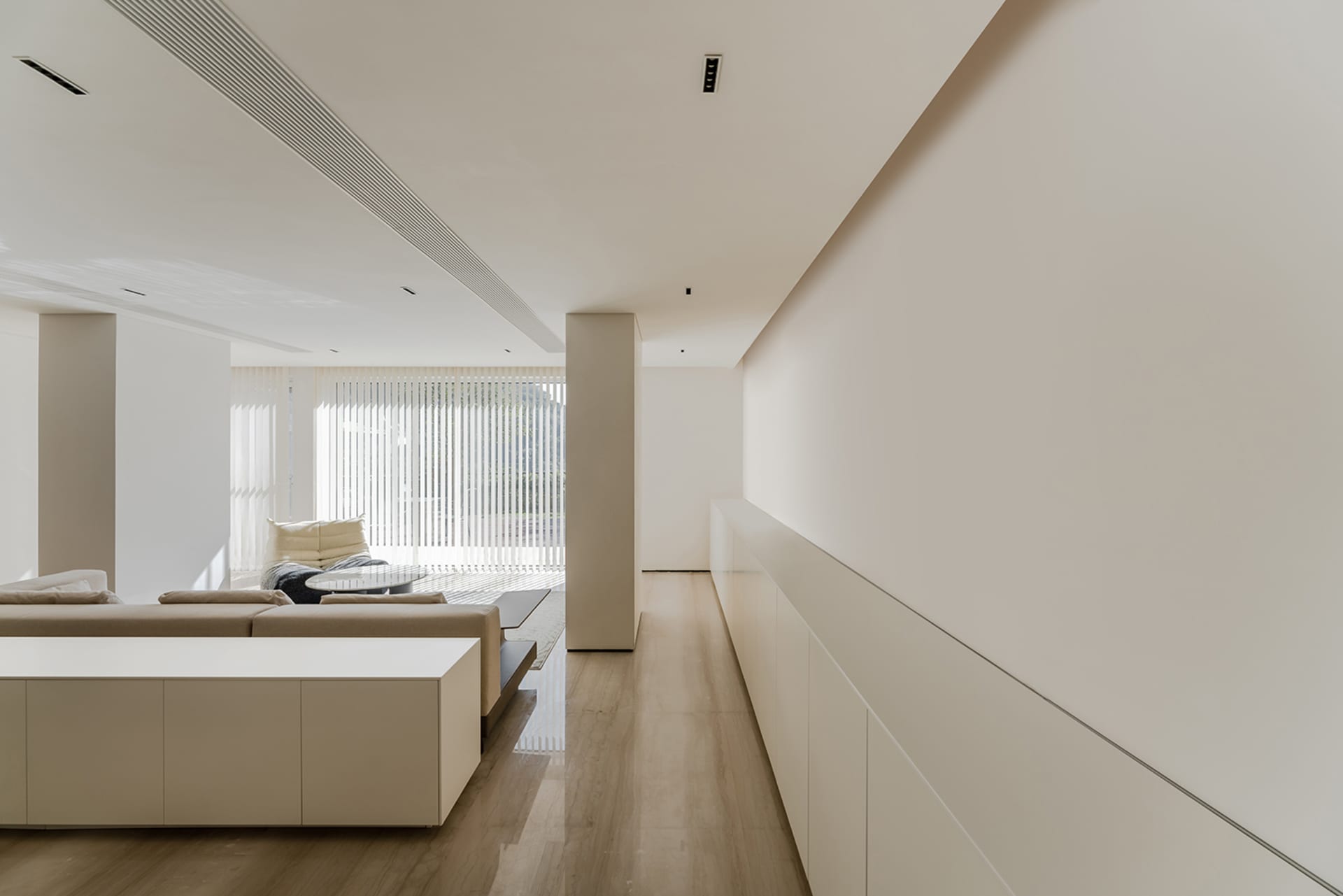 A minimalist interior design featuring concrete walls and flooring.